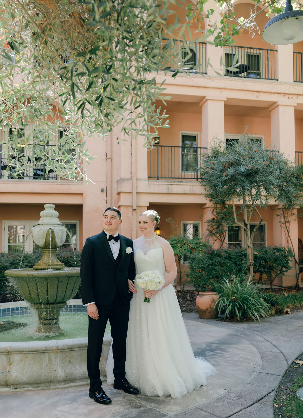 Bride and groom laughing while posing for wedding photos at Napa Valley wedding venue