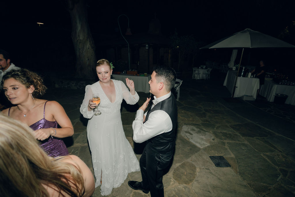 Candid wedding reception photo of bride and groom dancing on their dance floor