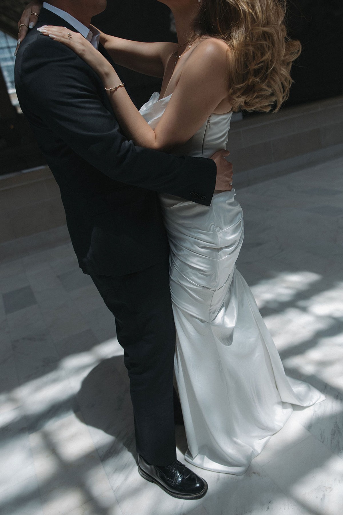 Blurry editorial wedding photo of couple dancing to celebrate their San Francisco City Hall elopement 