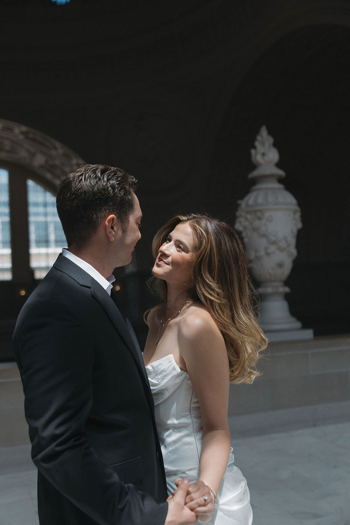 Romantic wedding photo of couple smiling at each other while dancing at their wedding at San Francisco city hall