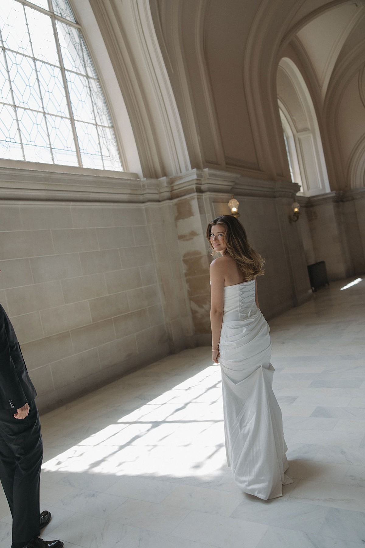 Bride turned around looking at her husband while walking away