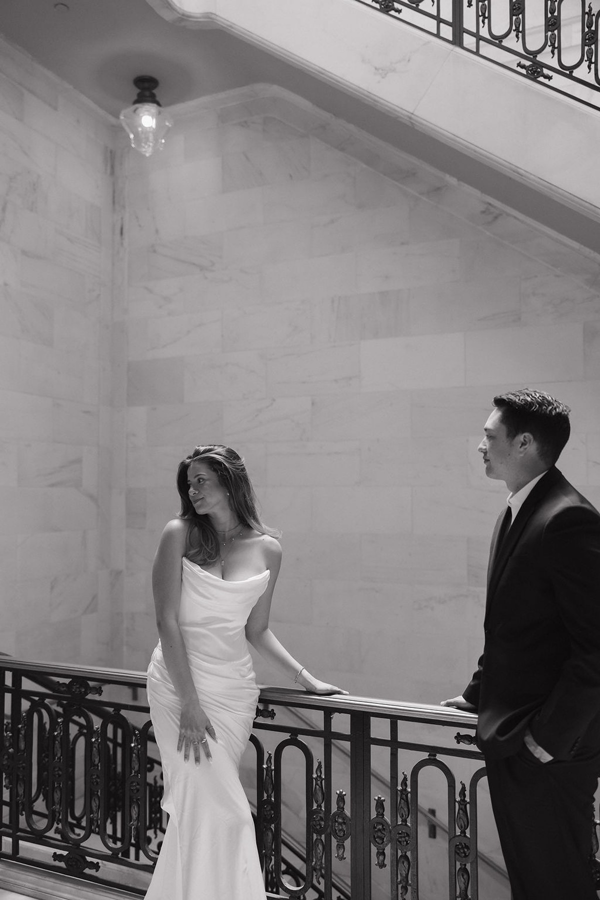 Black and white wedding photo of couple posing in San Francisco City Hall wedding