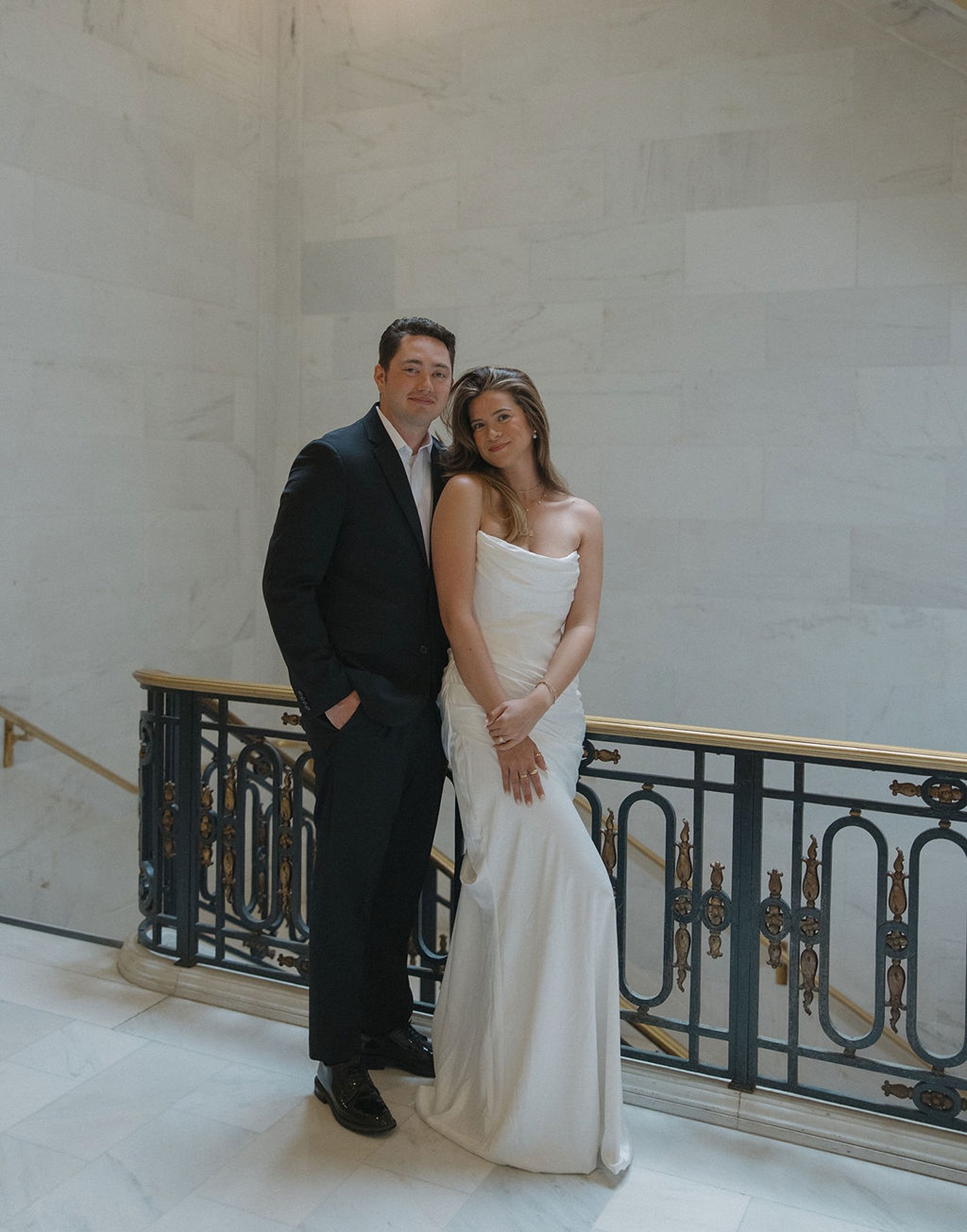 Bride and groom smiling and posing for elopement photos at San Francisco city hall