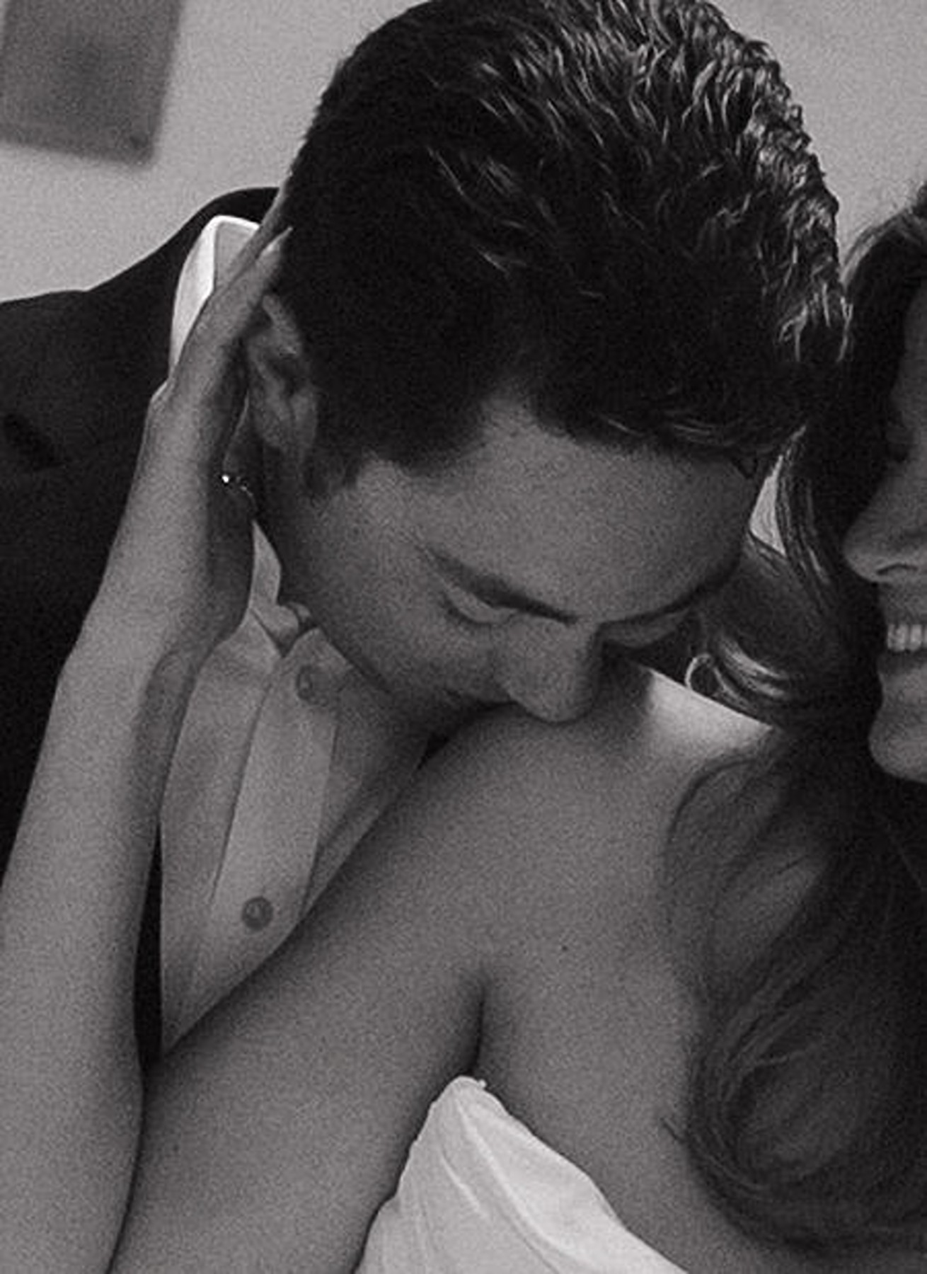 Editorial up close wedding photo of groom kissing bride's shoulder