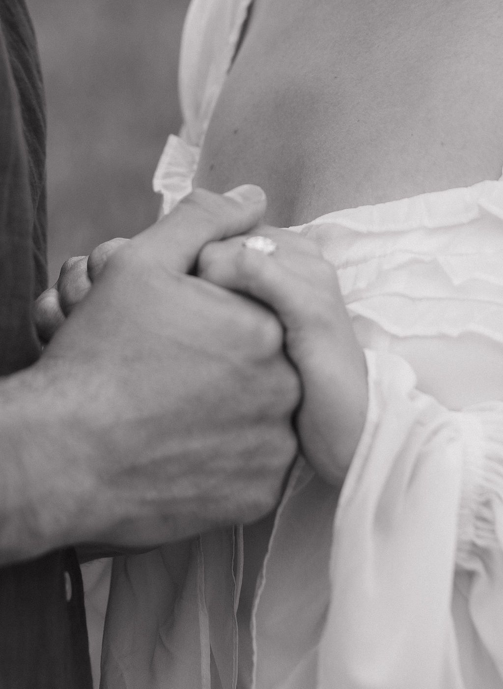 An up close photo of couple holding hands during their engagement photoshoot