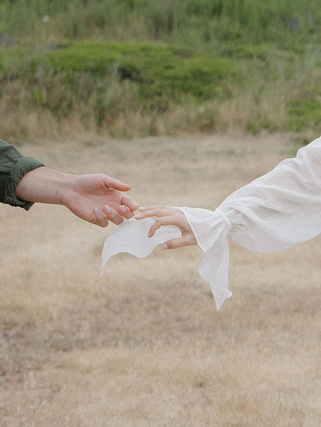 Couple reaching for each other's hands 
