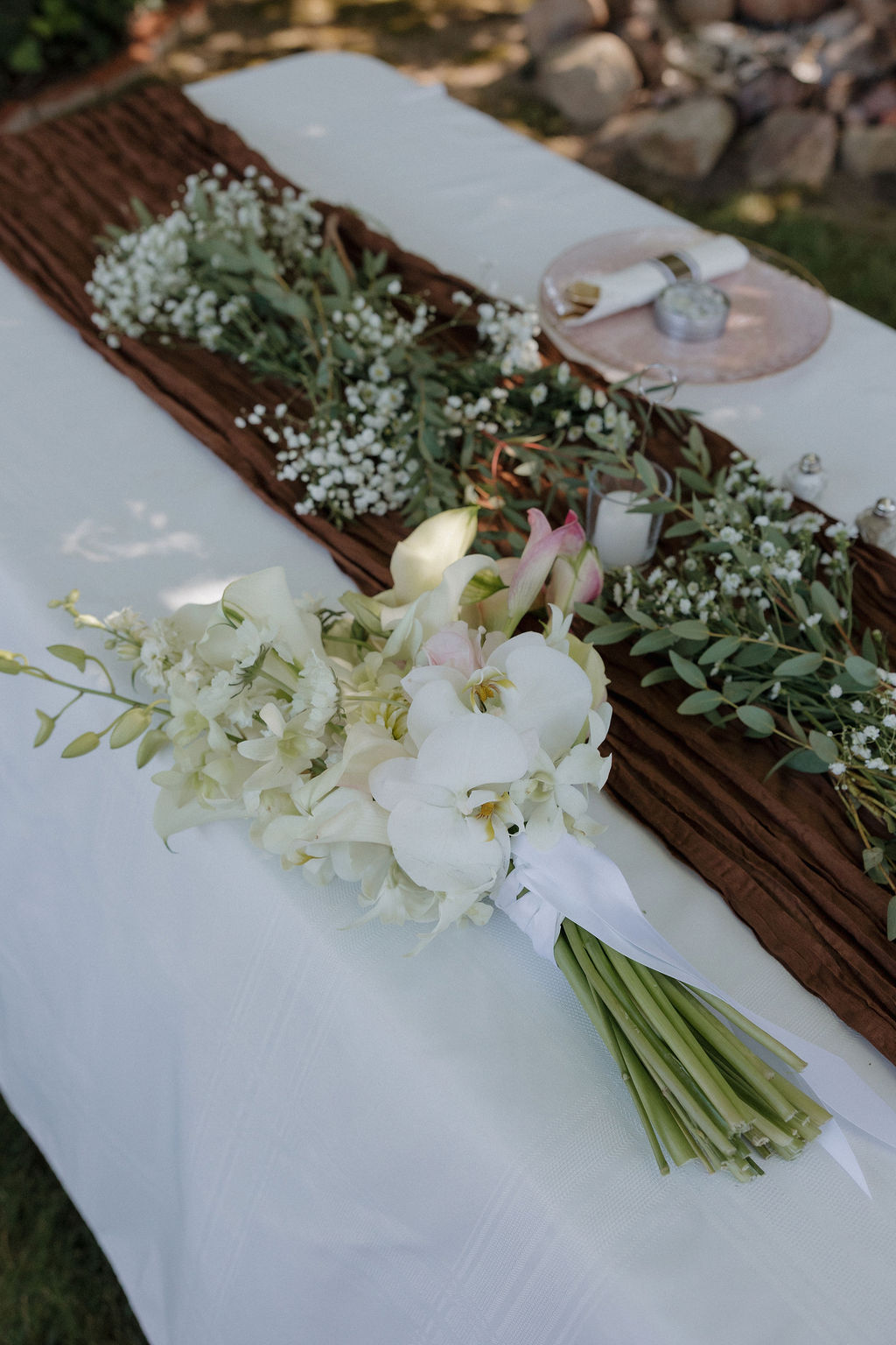 A calla Lily wedding bouquet laying on a wedding reception table