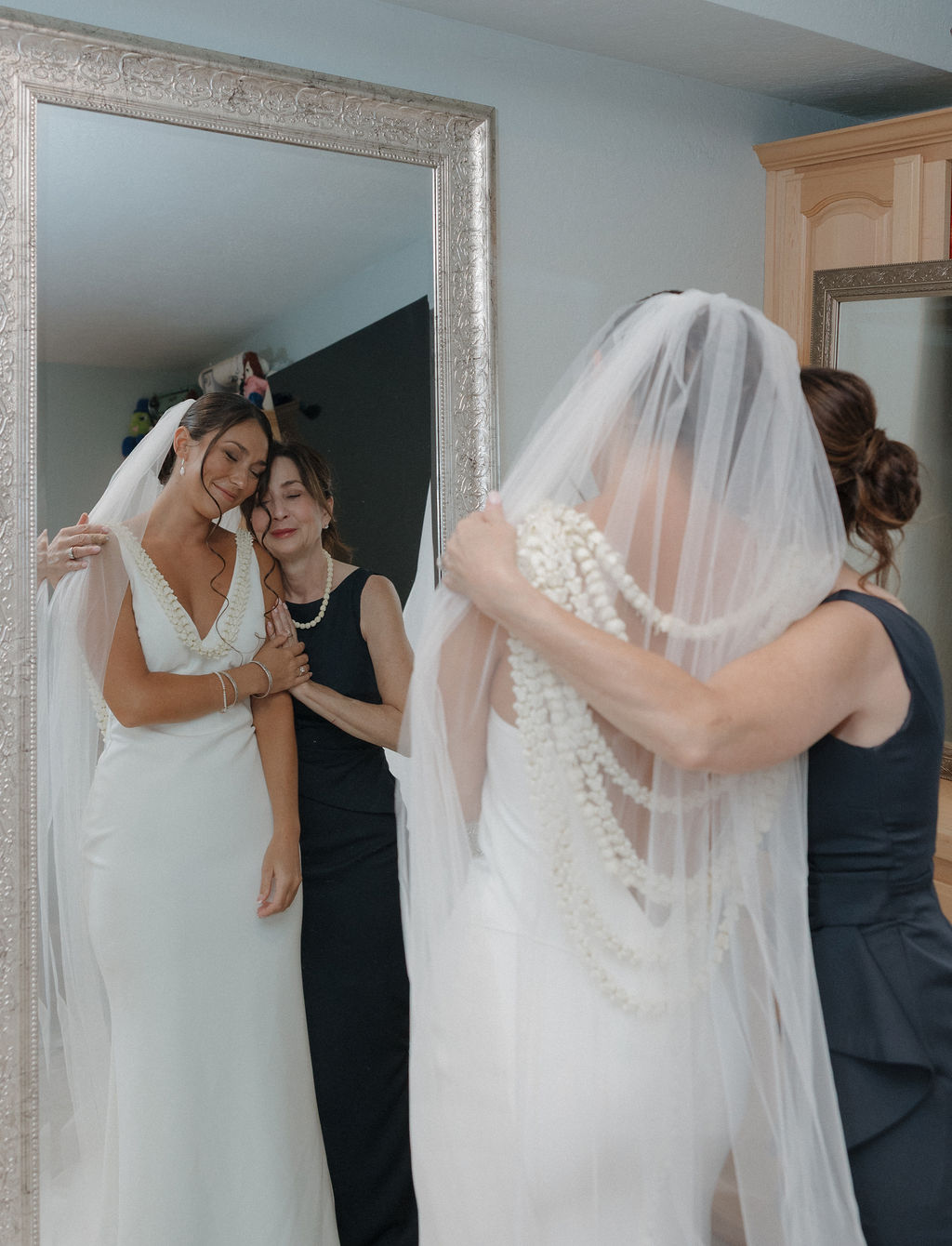 Bride's mom hugging her during getting ready wedding photos