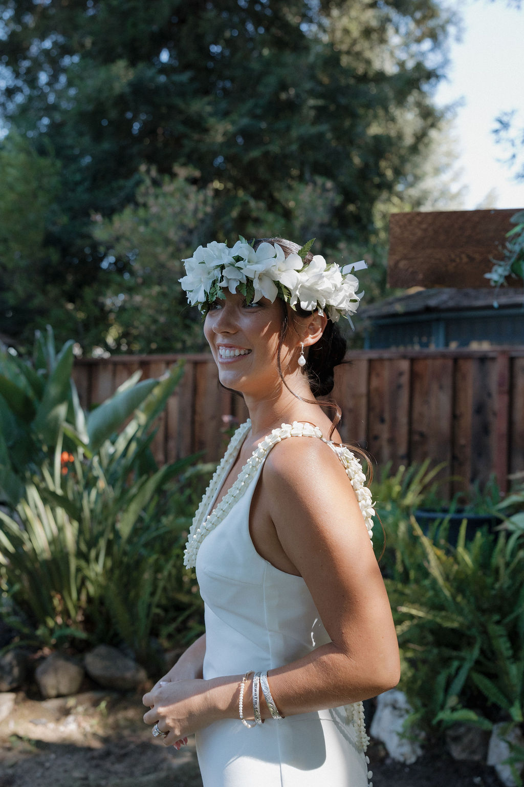 Candid bridal portrait of bride in a simple elegant wedding dress with a flower crown