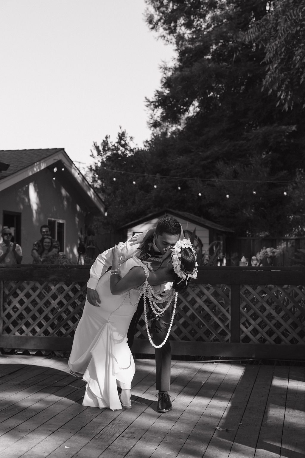 Black and white photo of groom dipping bride during first dance