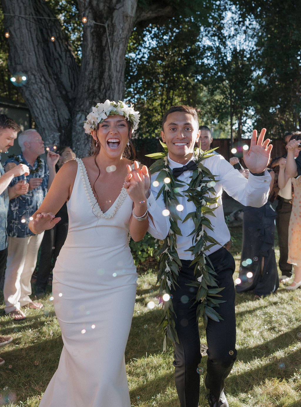 Bride and groom laughing during bubble send off as wedding send off