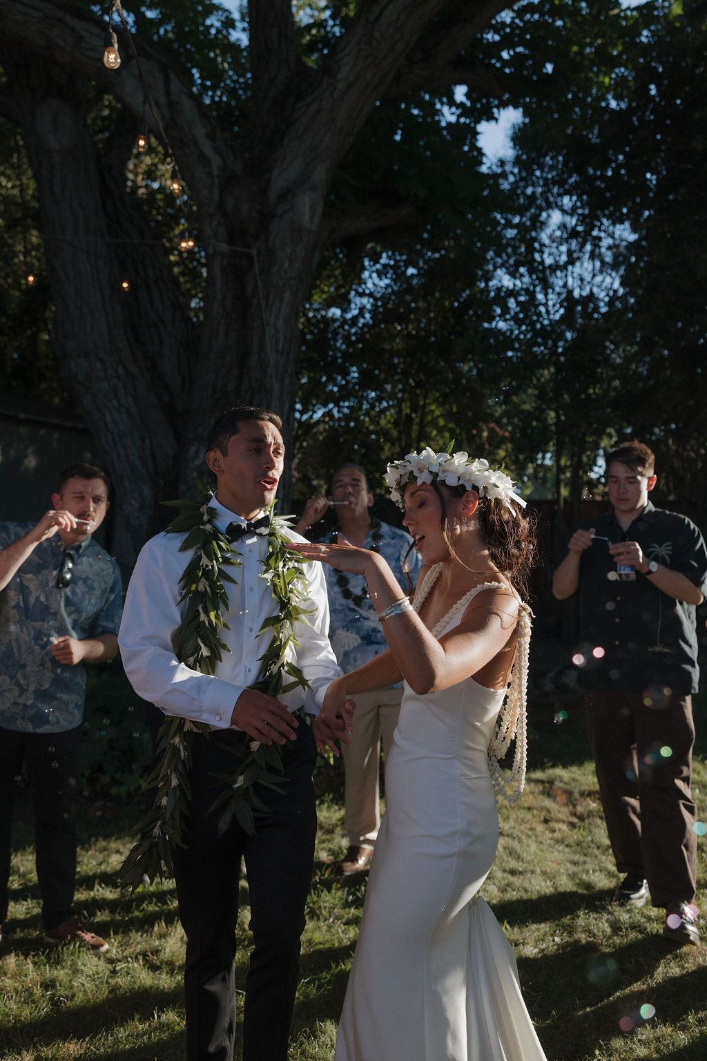 Candid wedding photo of bride and groom dancing during their outdoor wedding reception