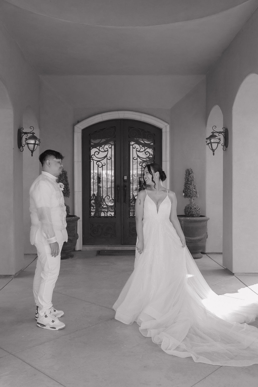 Black and white bride and groom photo in front of Estate
