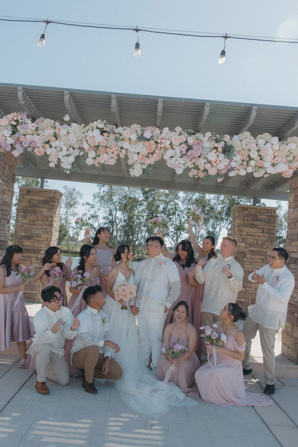 Bridal party photos at lakefront wedding ceremony site at Sacramento wedding venue