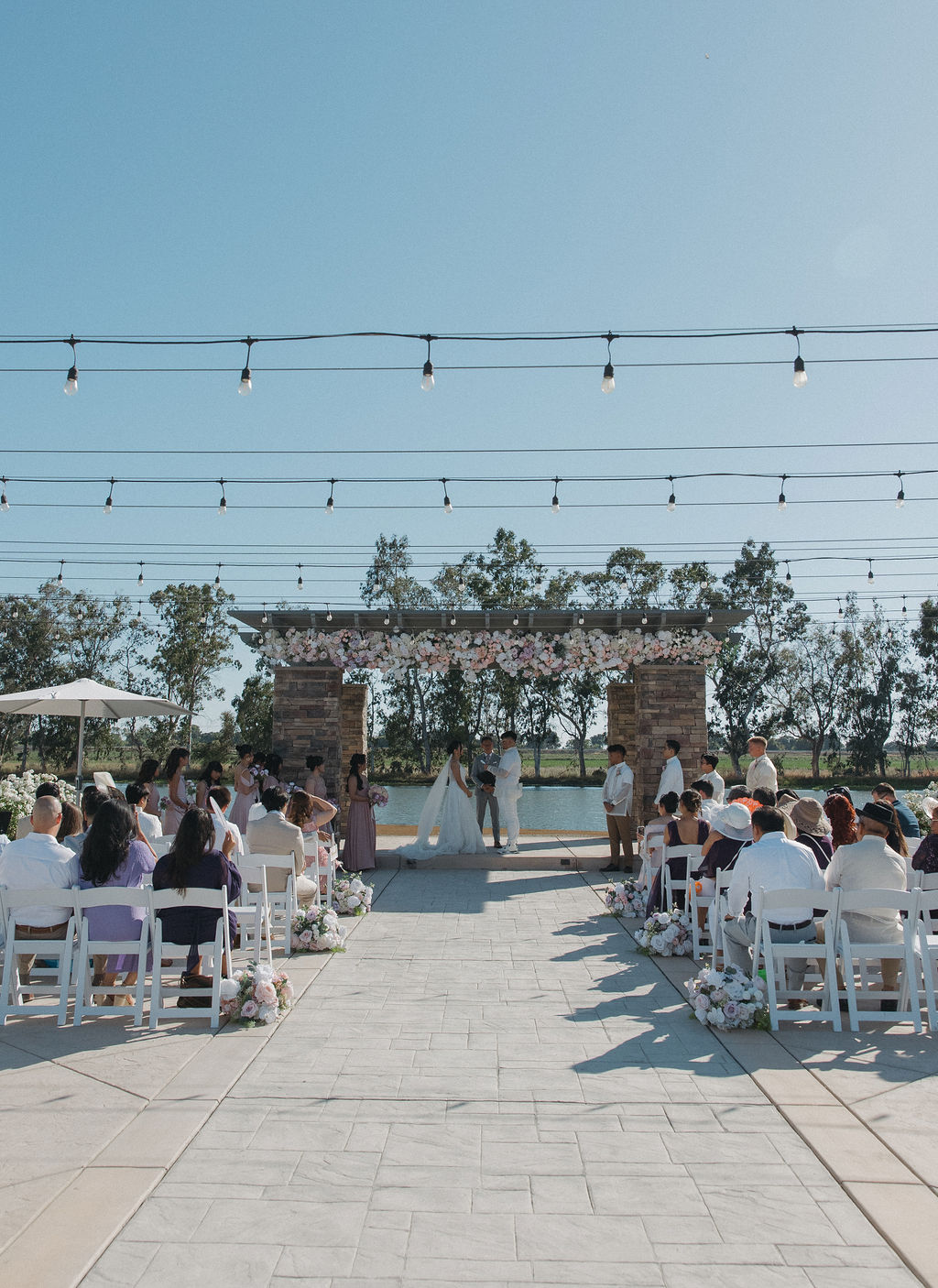 A far view of a lakefront wedding ceremony 