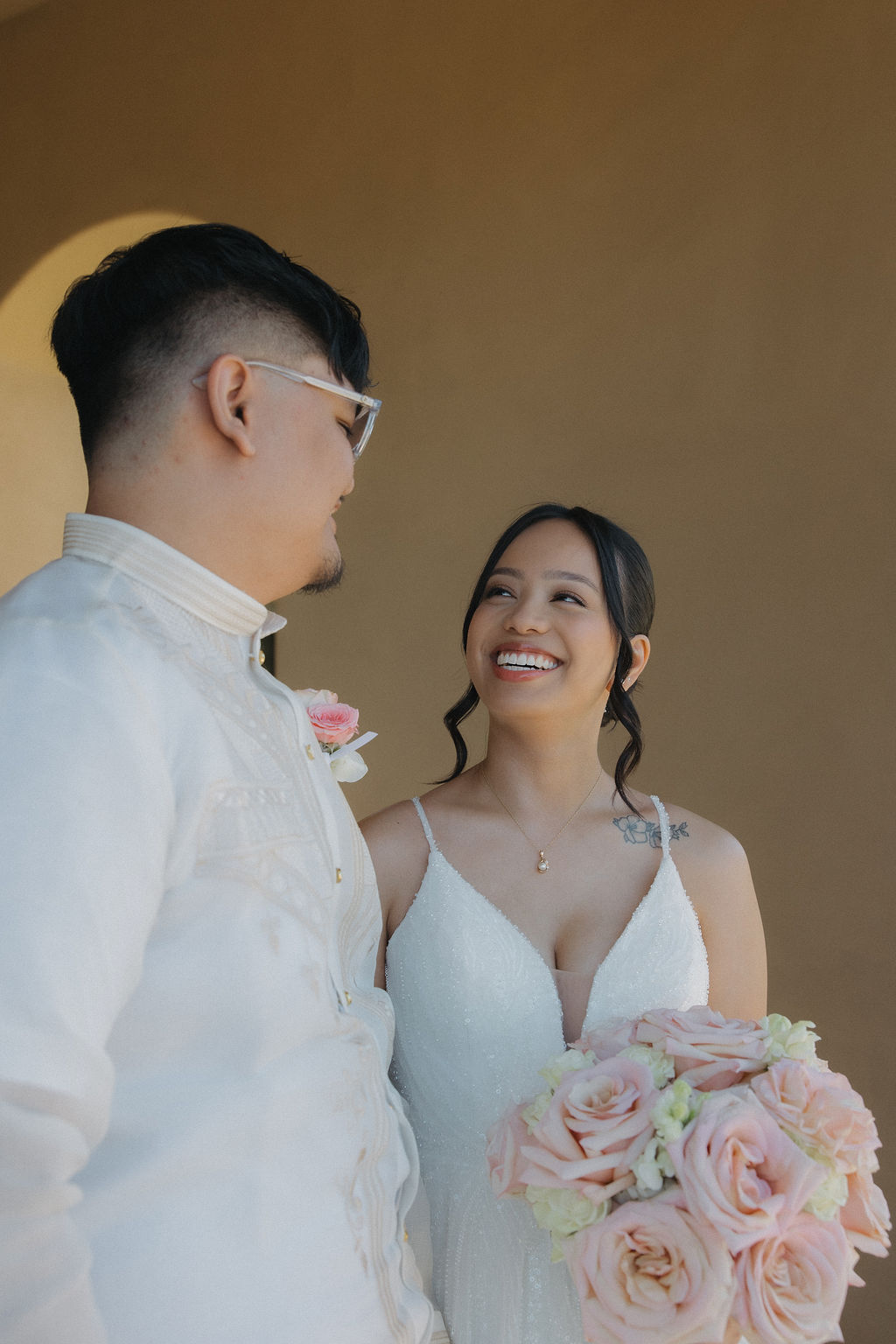 Bride smiling at groom during portraits