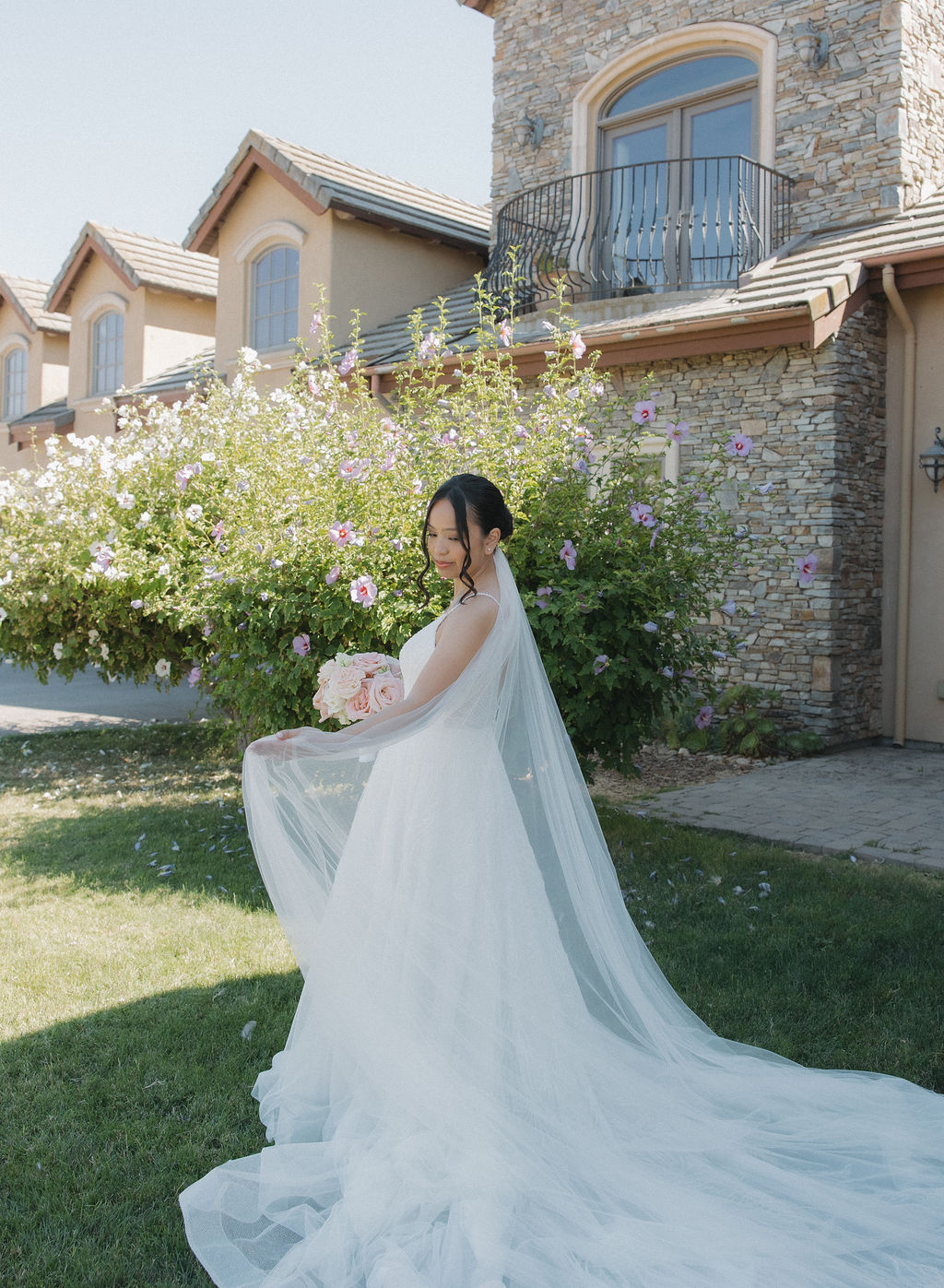 Bridal portrait with bride swinging her veil for an editorial bridal portrait