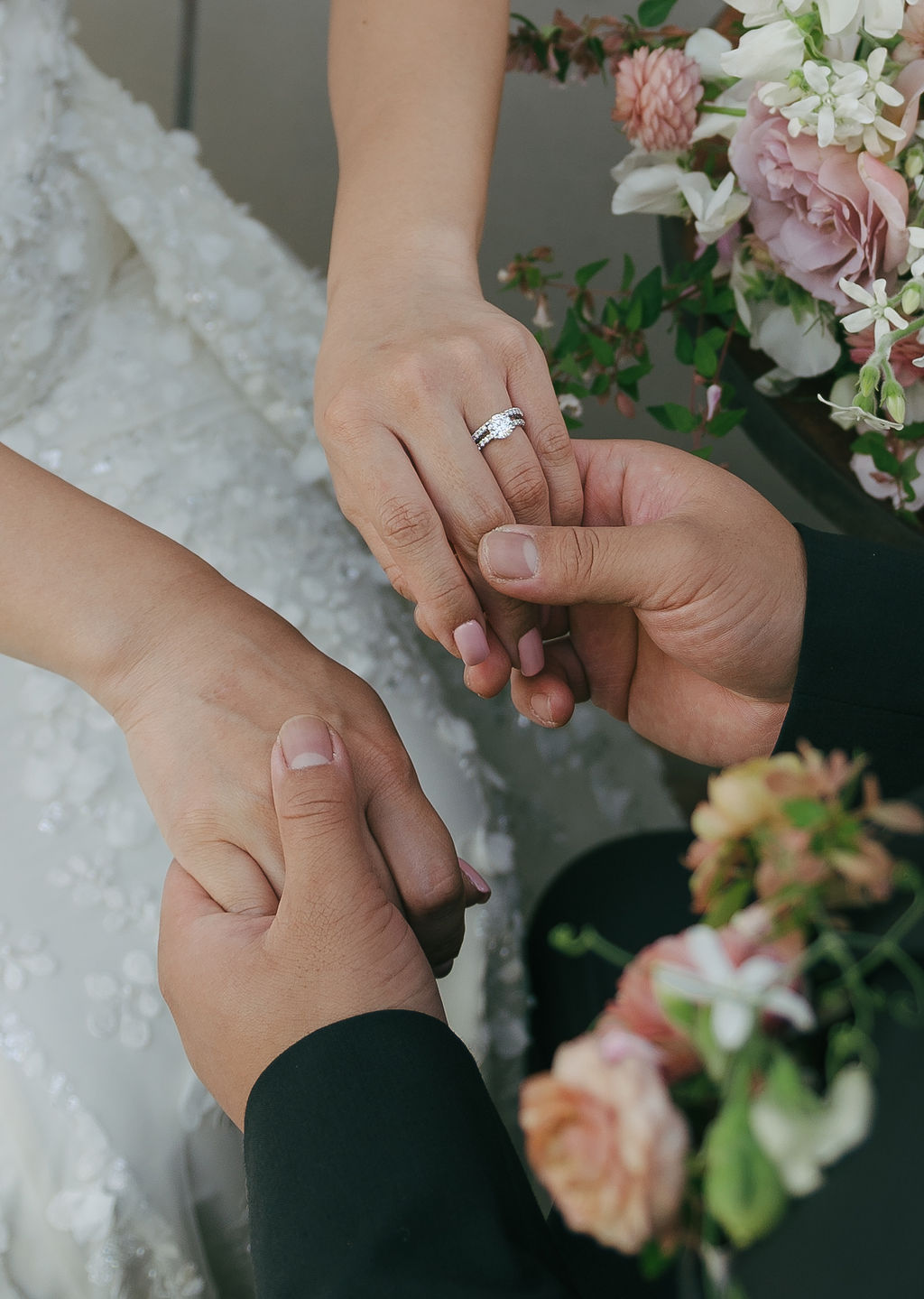 Wedding photoshoot inspo of groom holding bride's hands