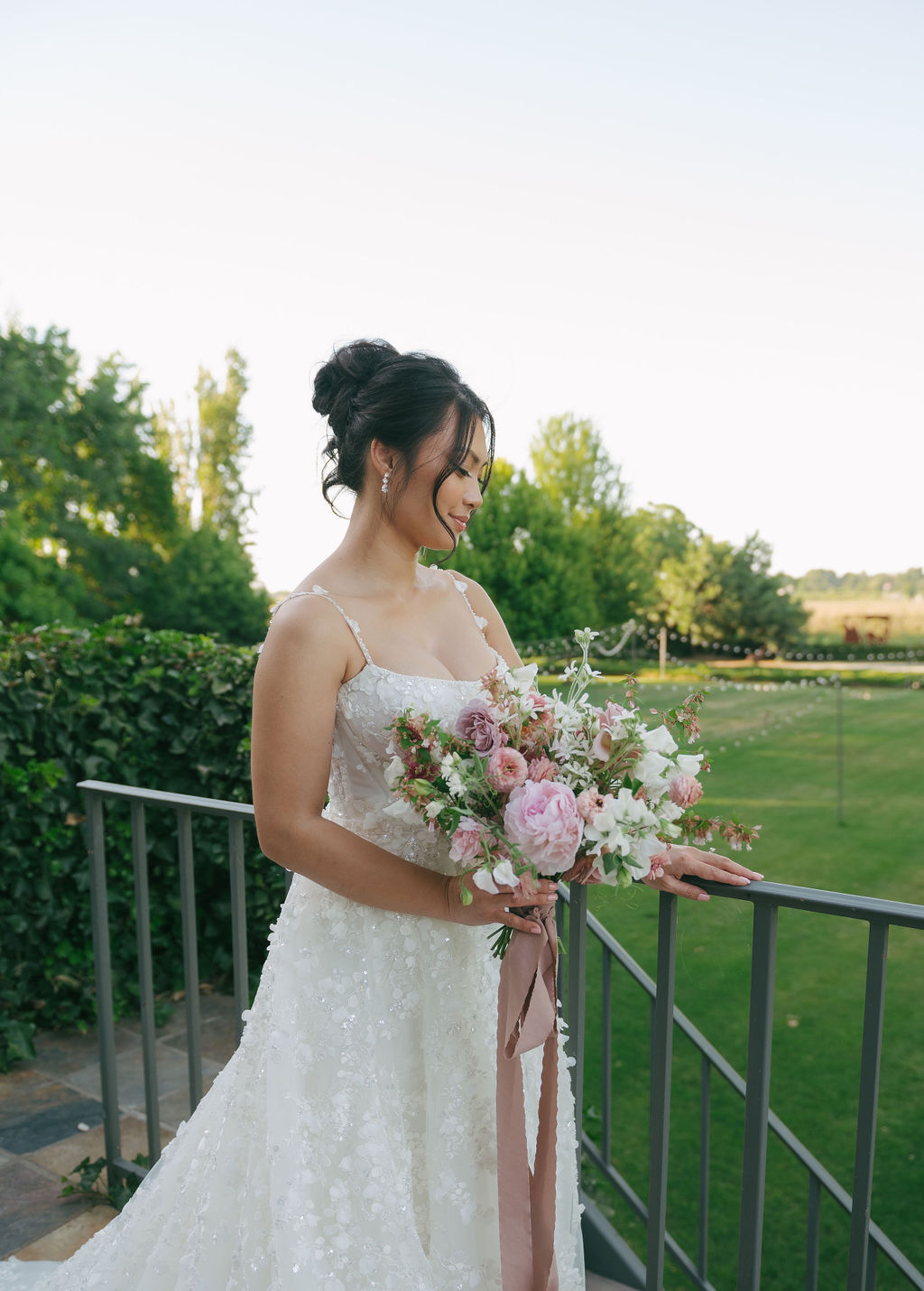 Bride looking down showing off her bridal hair and makeup