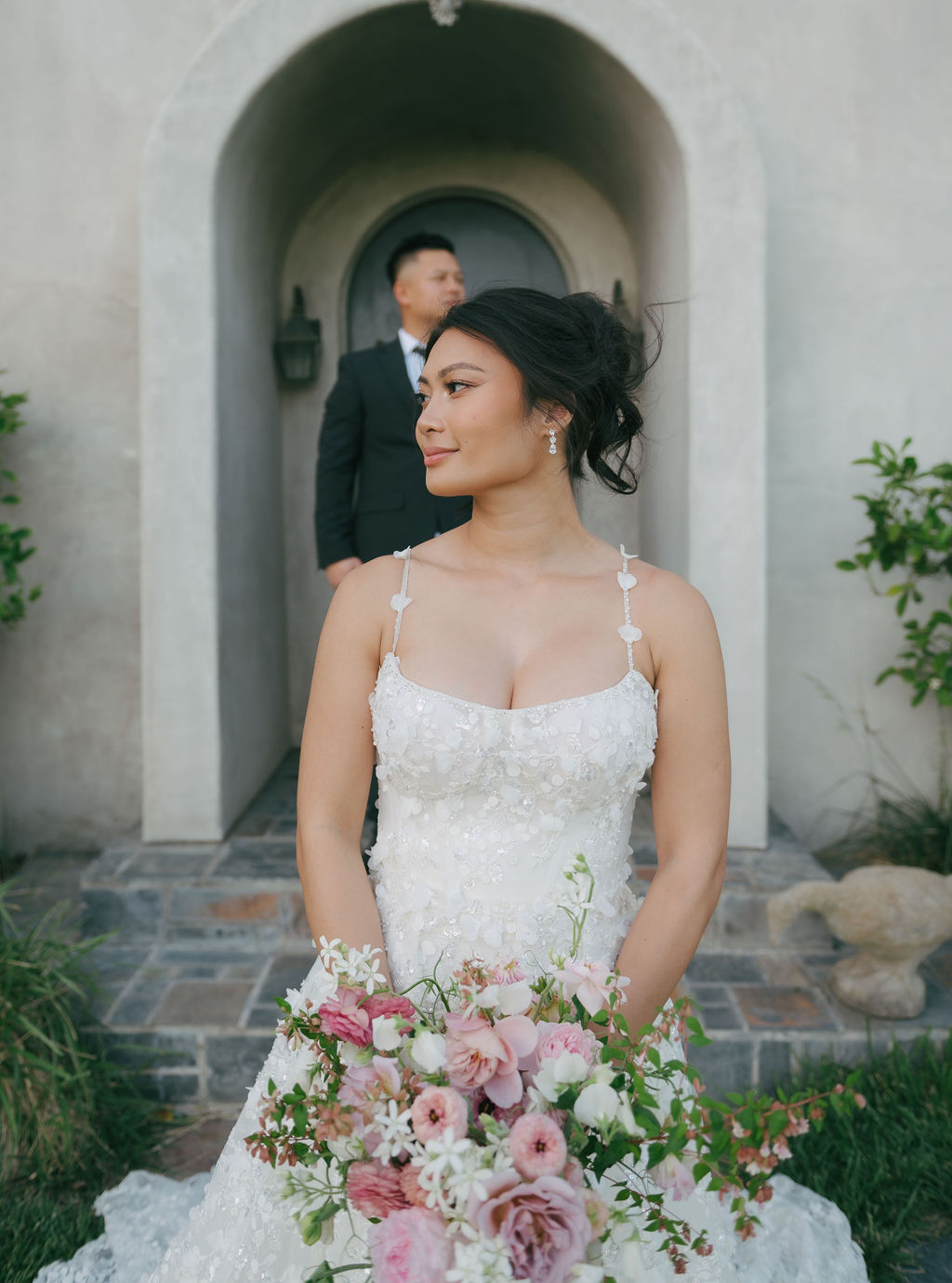 Bridal portrait with groom standing out of focus behind her during wedding portraits