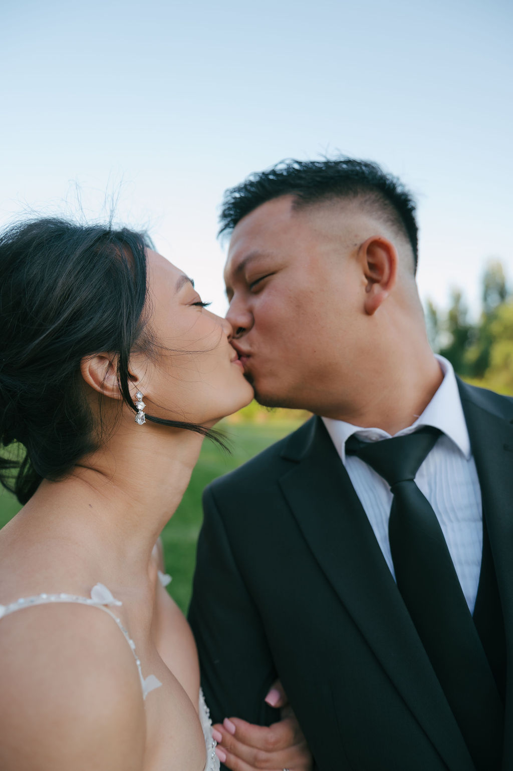 Bride and groom kissing in an up close wedding portrait