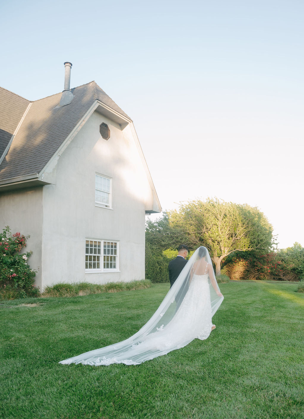 Bride and groom walking on the lawn of Cavaignac Estate