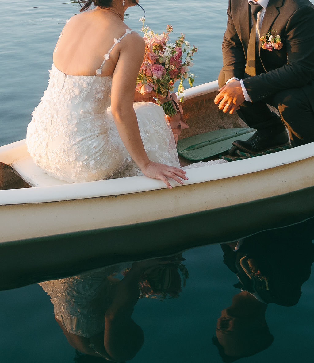Editorial wedding photo of bride and groom in a row boat