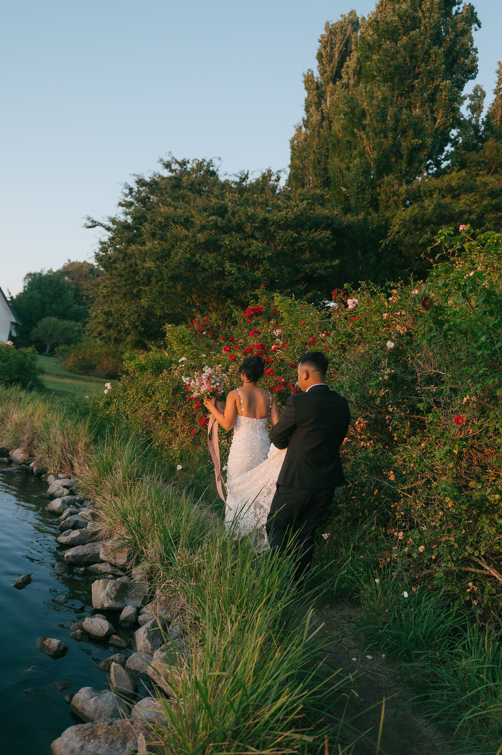 Couple walking away from camera in a garden
