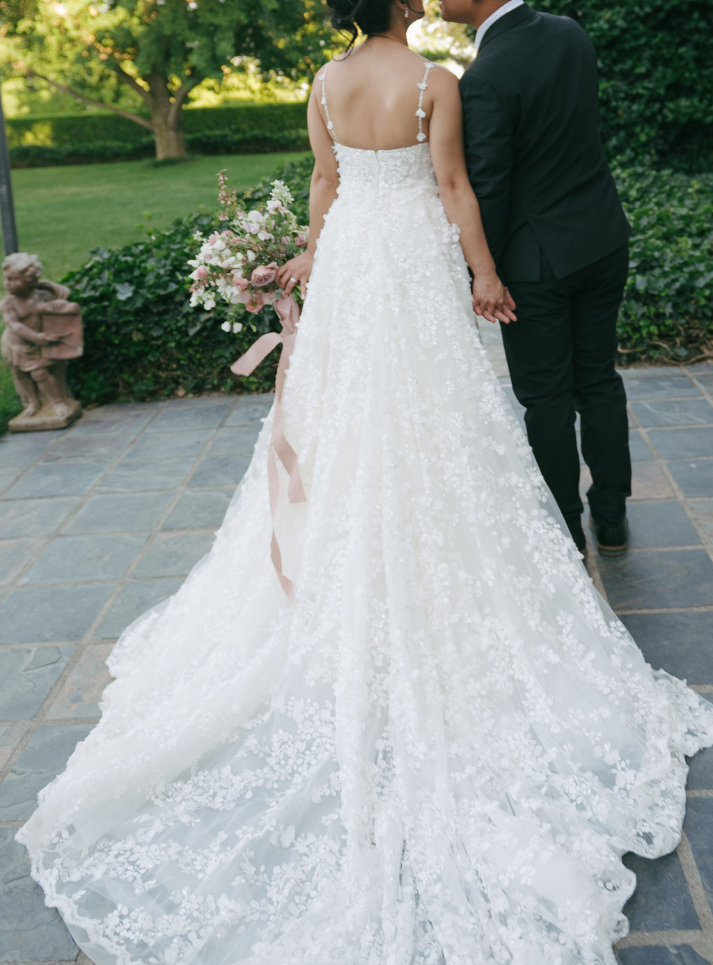 Bride and groom turned away from camera kissing