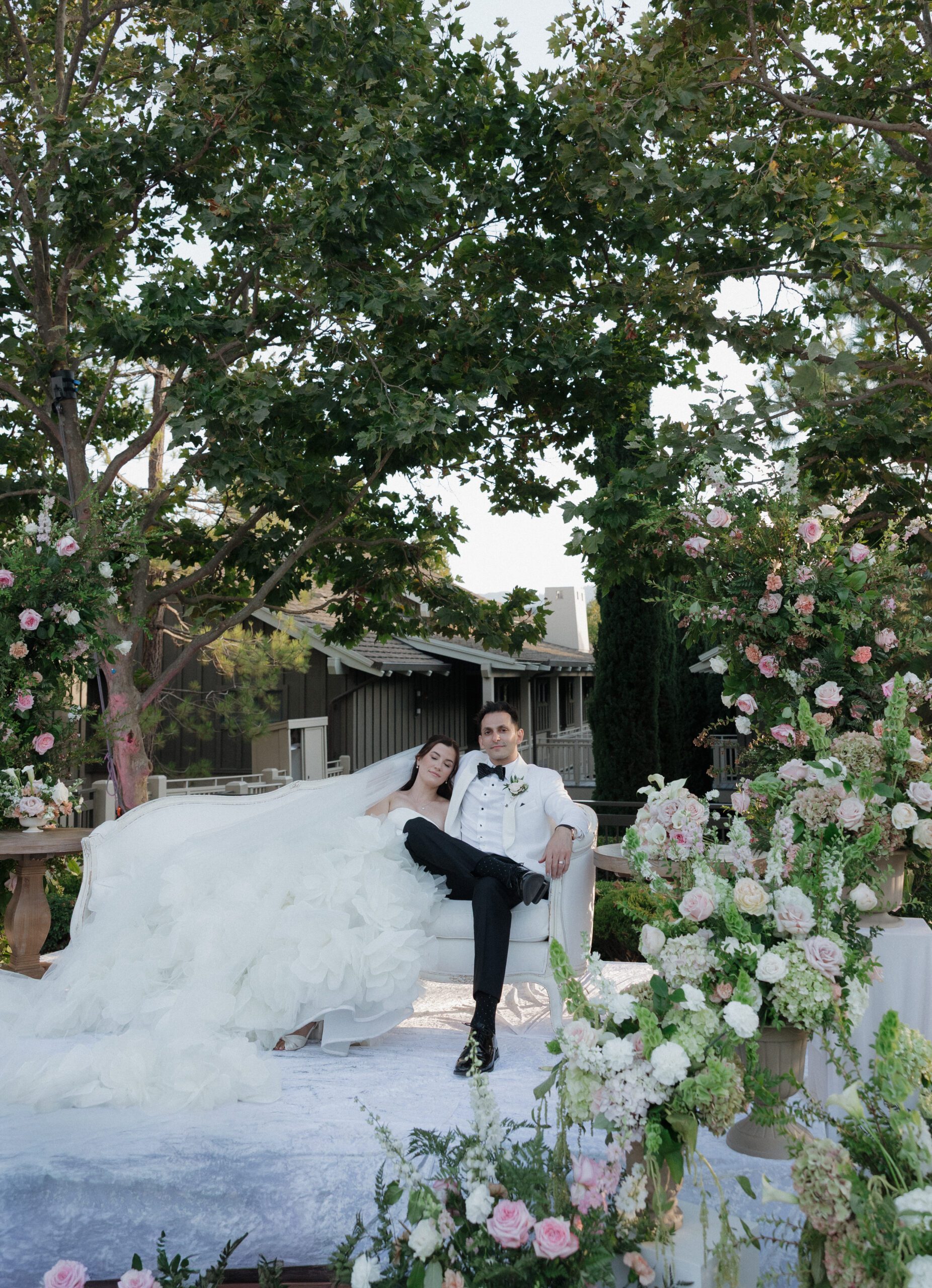 Bride and groom sitting on a couch overlooking the dance floor