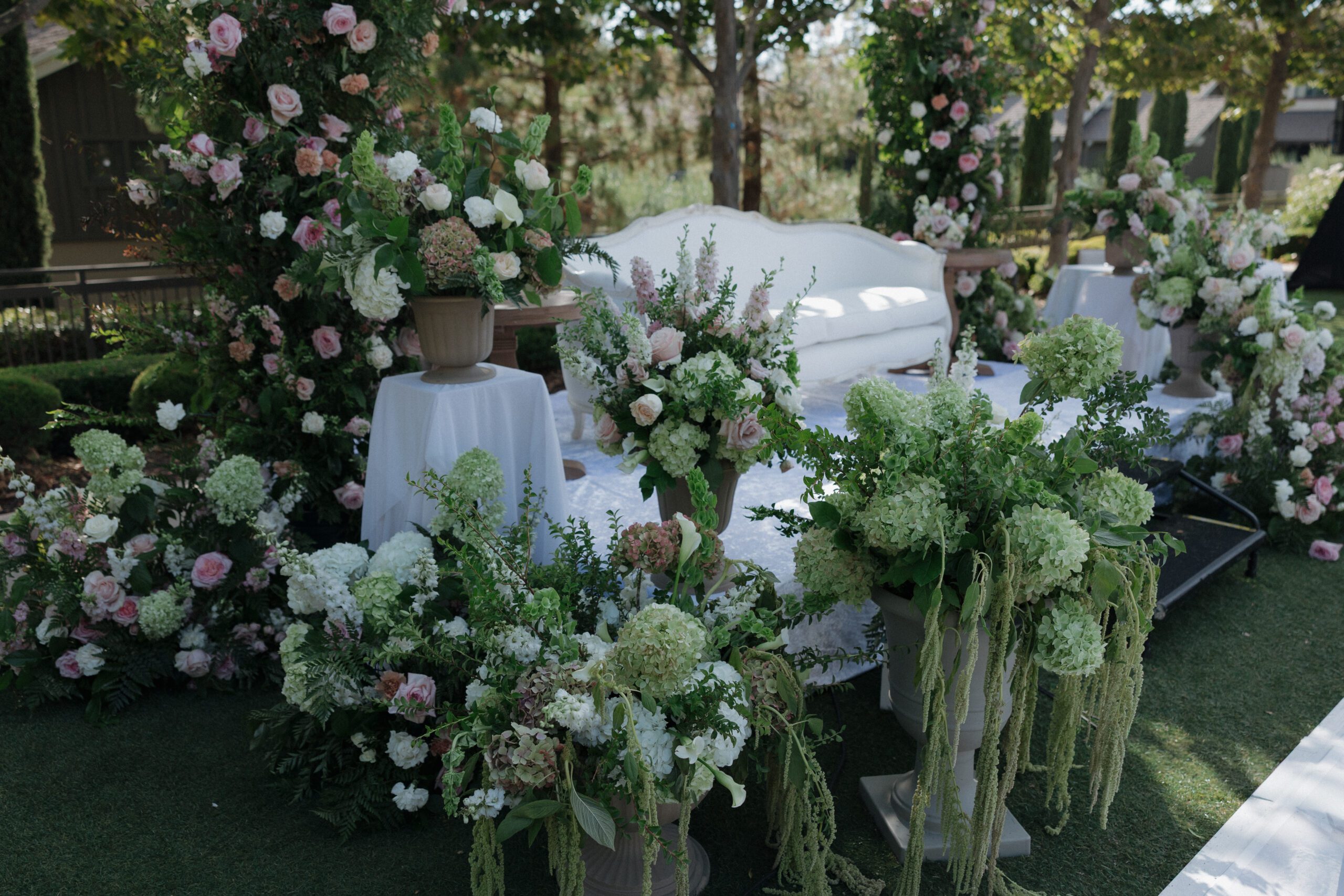 A couch at a wedding overlooking the dance floor