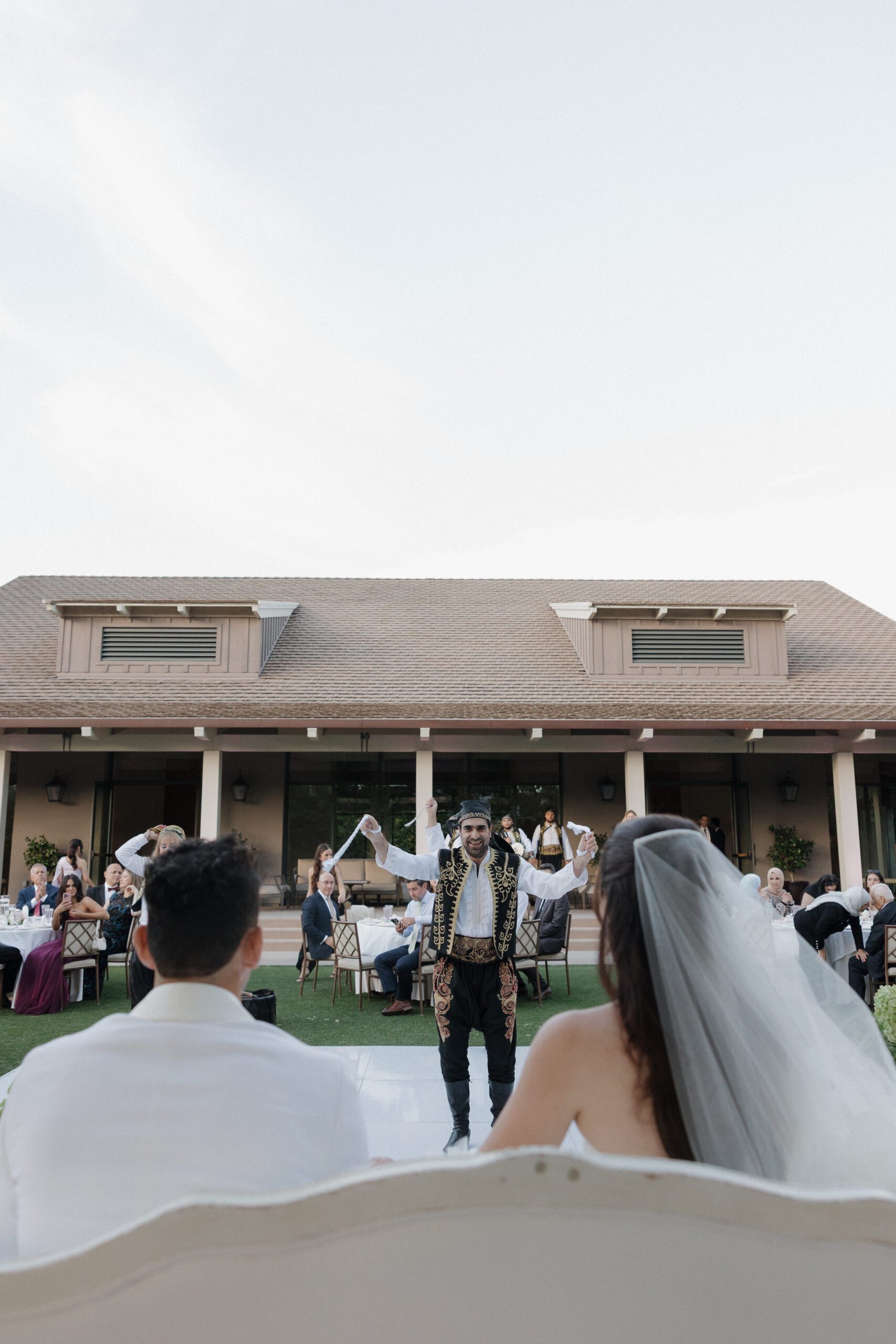 Bride and groom watching a live band performance from a couch