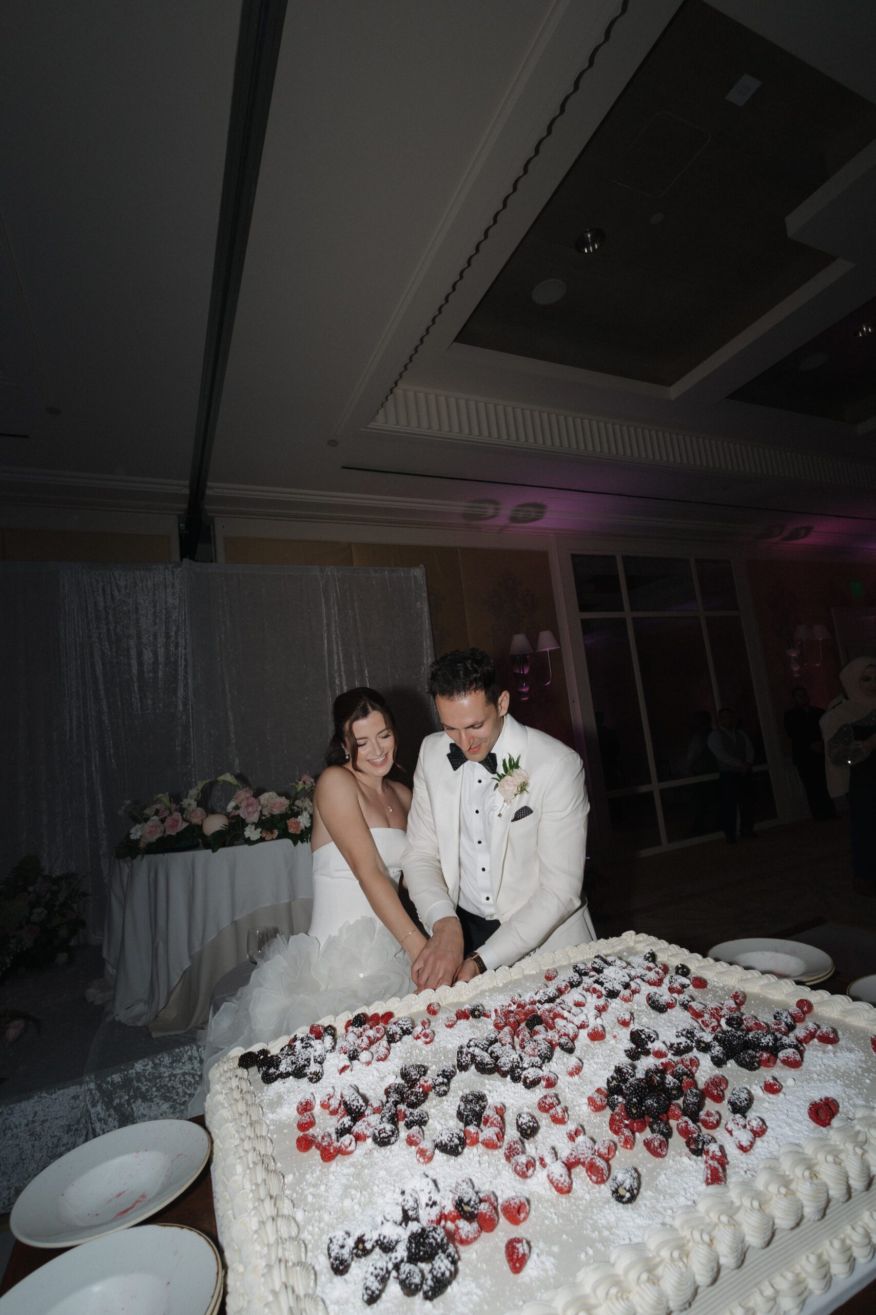 Bride and groom cutting their sheet cake at their wedding reception