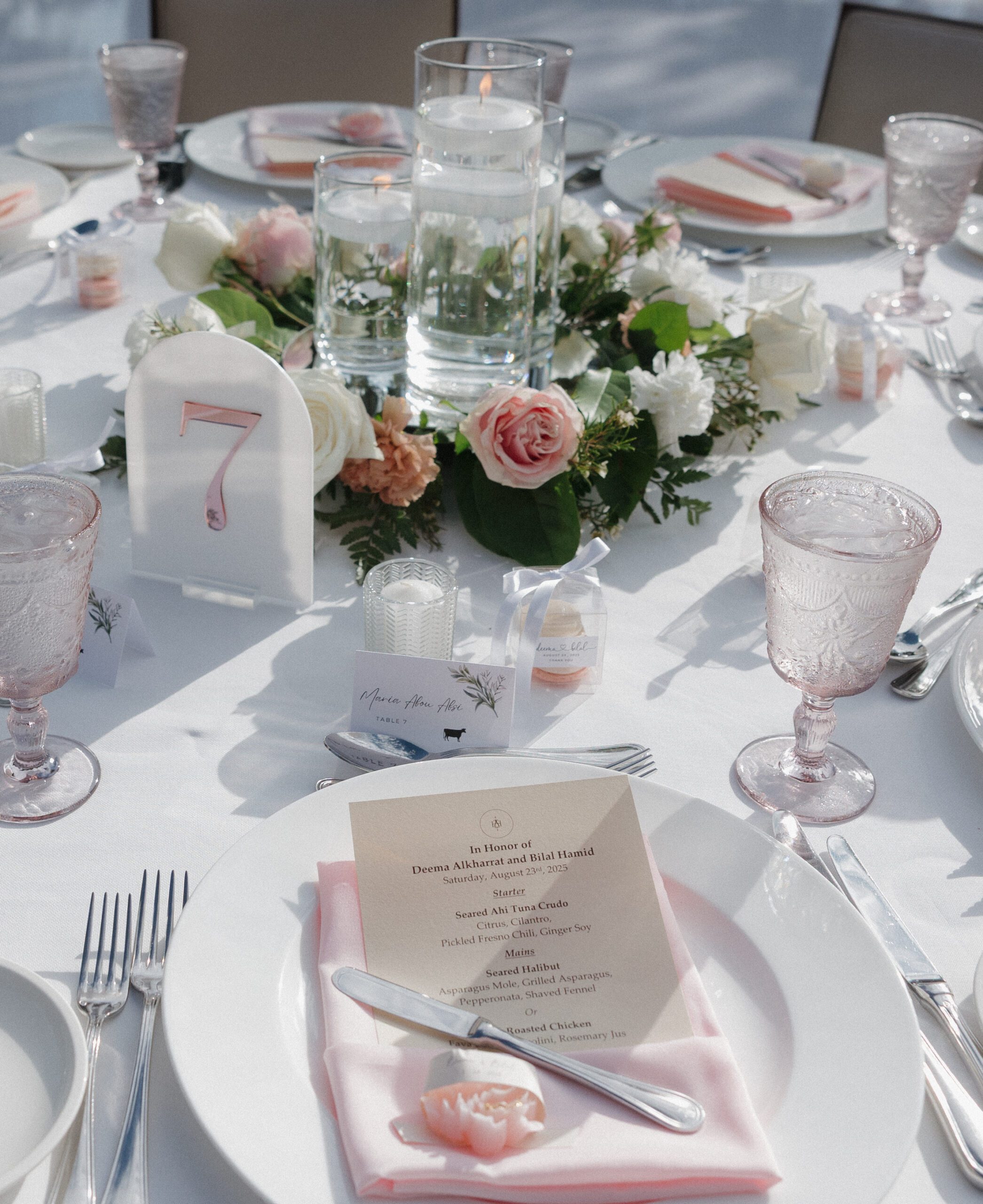 Wedding table setting with pink centerpieces