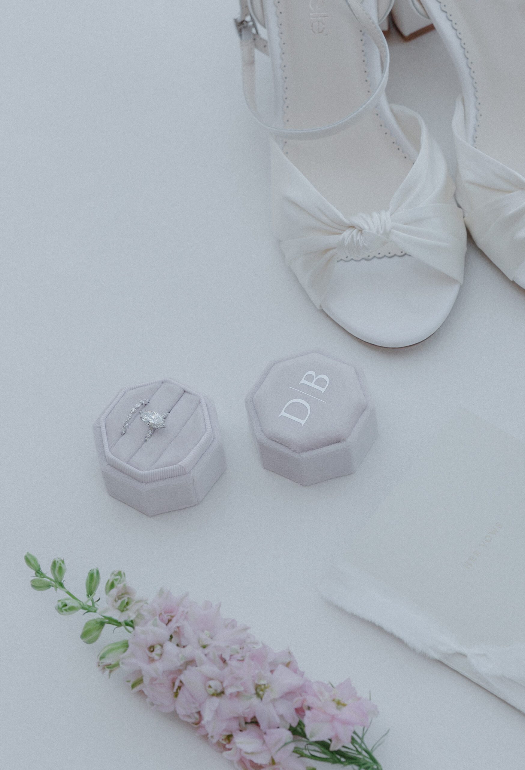 Wedding flatly photo of wedding shoes, rings, and florals