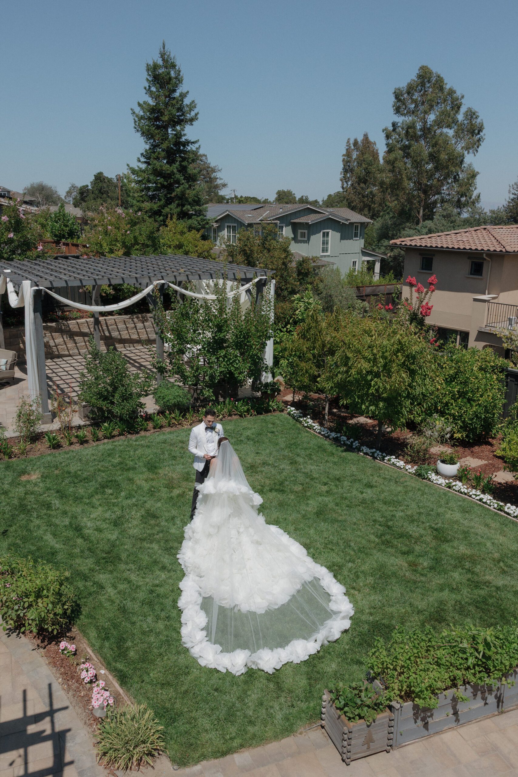 Arial view photo of bride and groom in courtyard lawn at Italian-inspired wedding