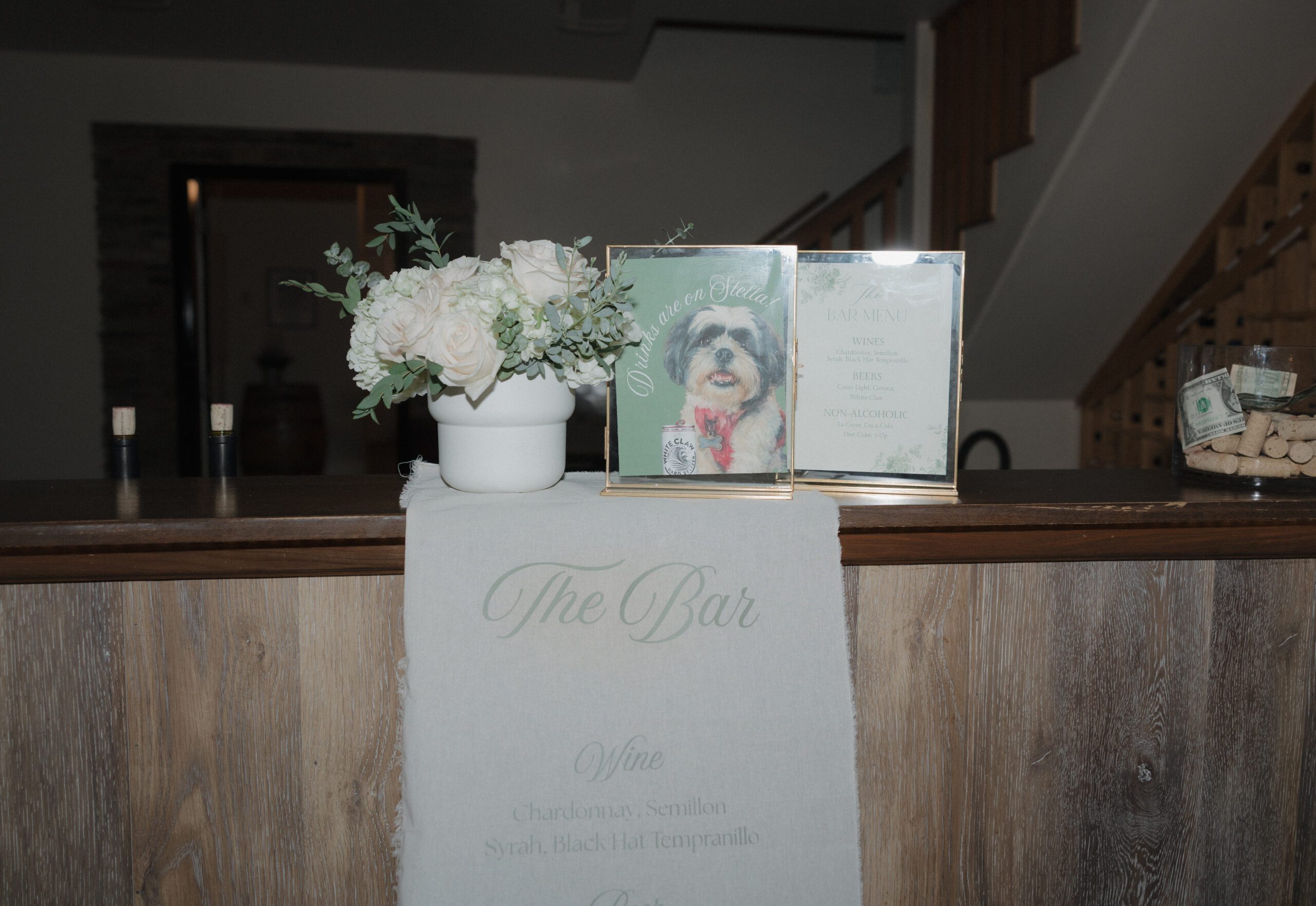 A photo of a wedding bar sign with a photo of the couple's dog