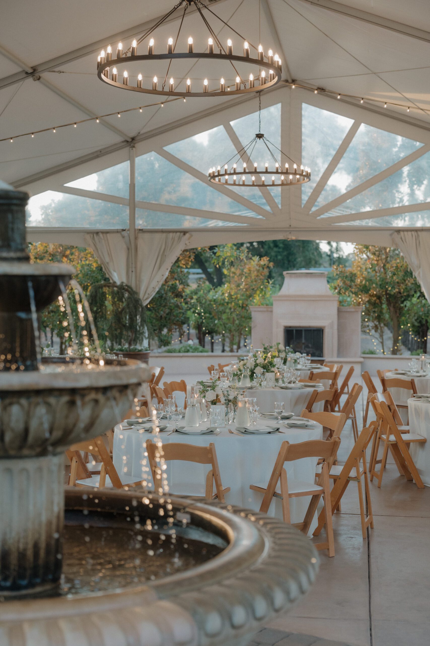 Wedding reception setup underneath an outdoor tent
