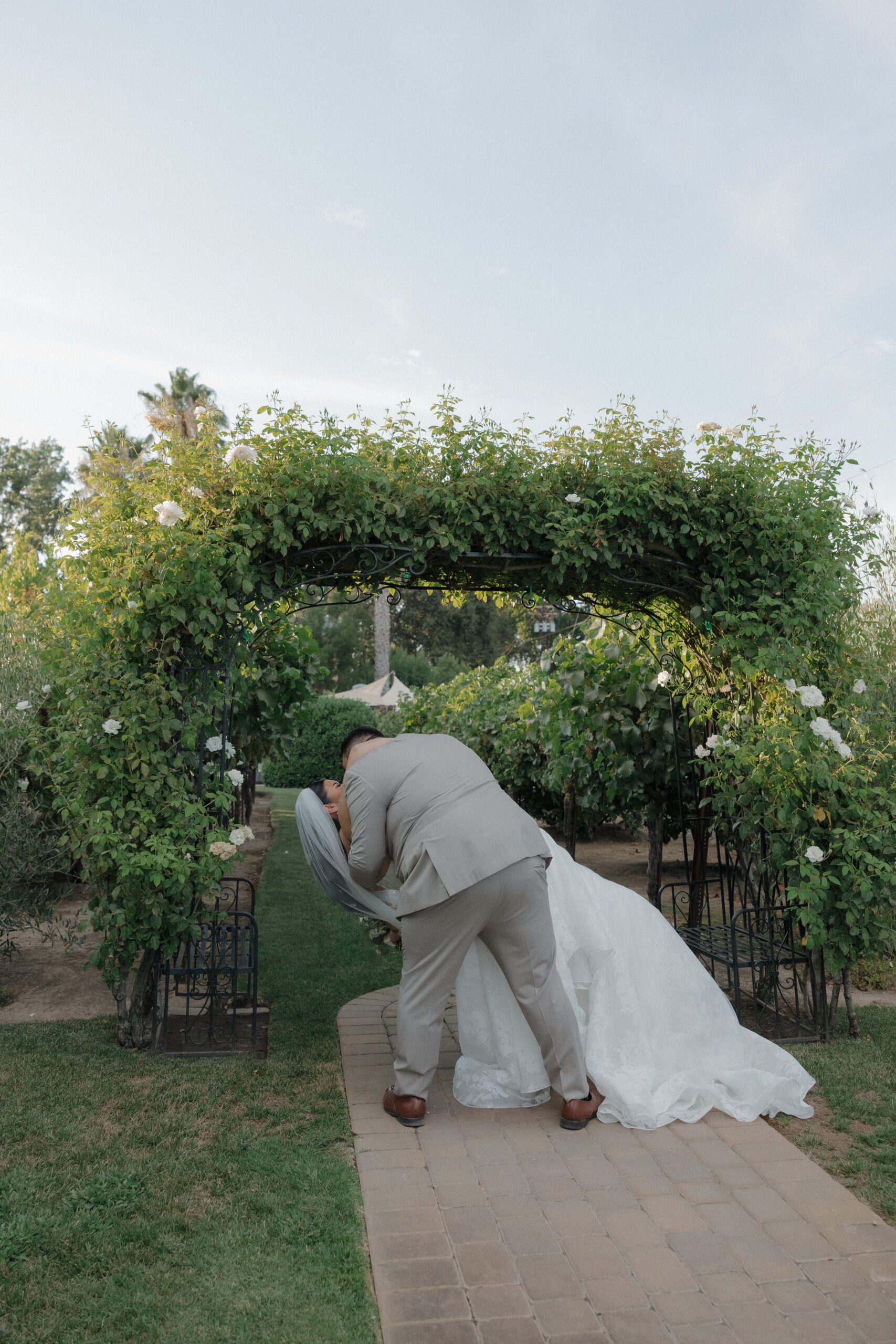 Bride and groom kissing on aisle after wedding ceremony
