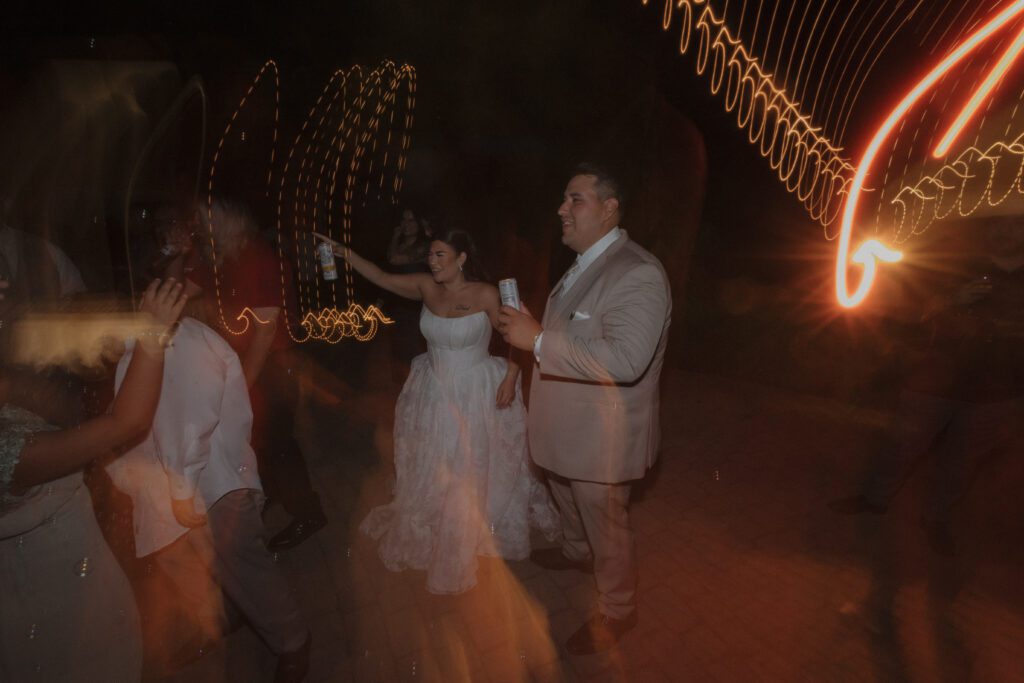 Editorial candid wedding reception photo of bride and groom dancing