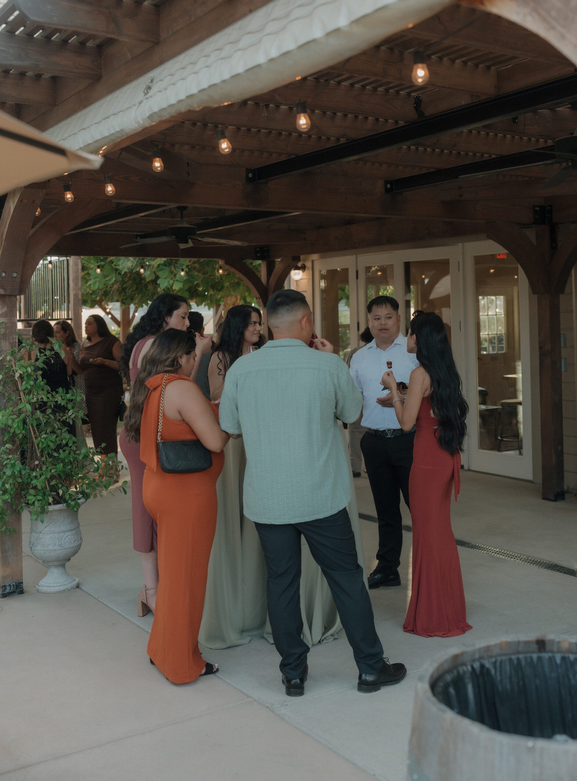 Candid wedding photo of guests at Cocktail hour on the patio at Scribner Bend Vineyards