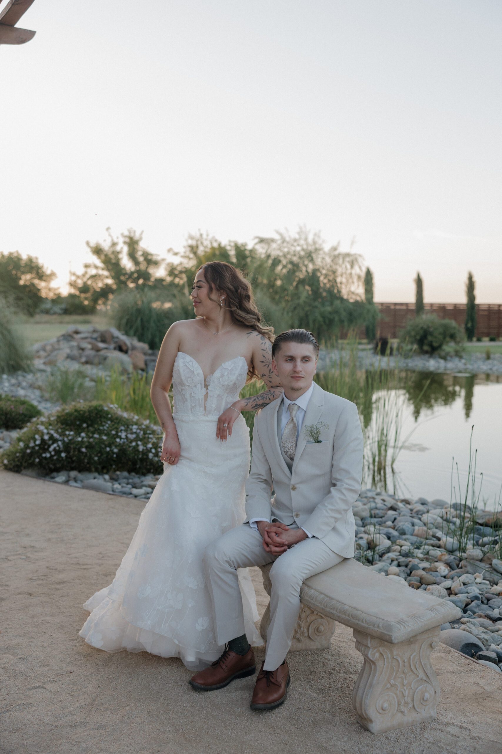 Bride and groom posing for editorial wedding photos at golden hour, showing the best time of year for a garden party wedding