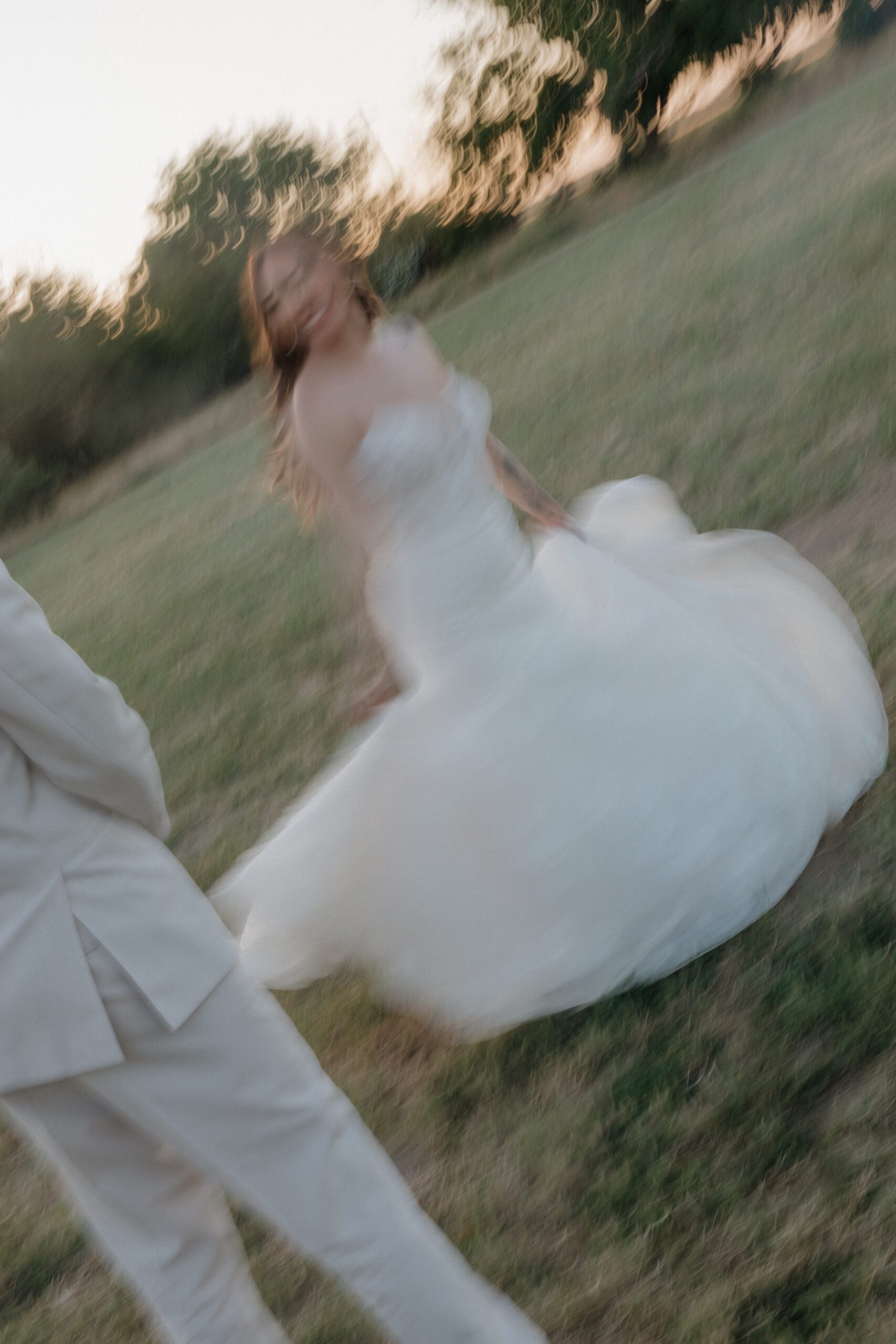 A blurry photo of bride spinning in her garden party wedding dress