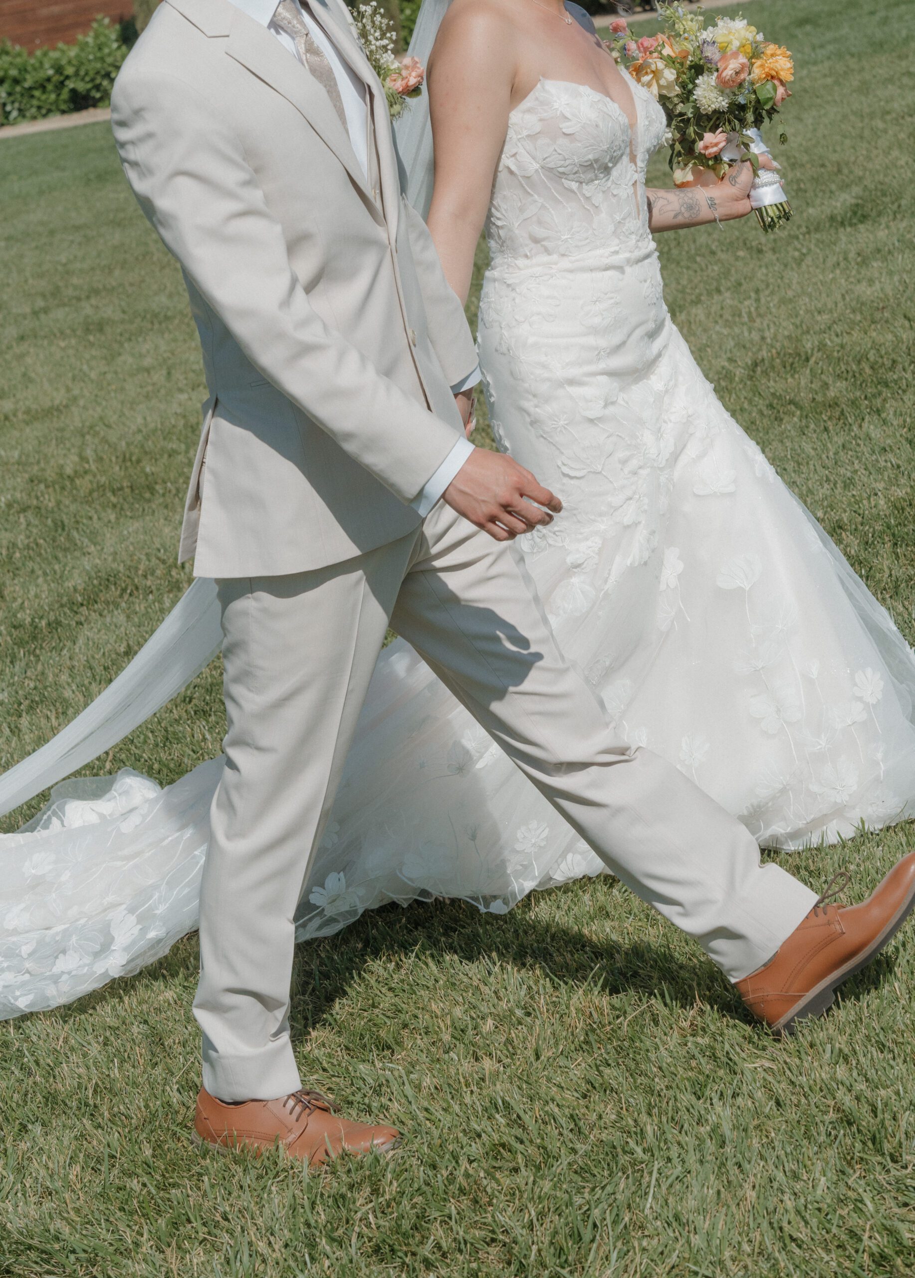 Bride and groom walking holding hands after leaving their ceremony