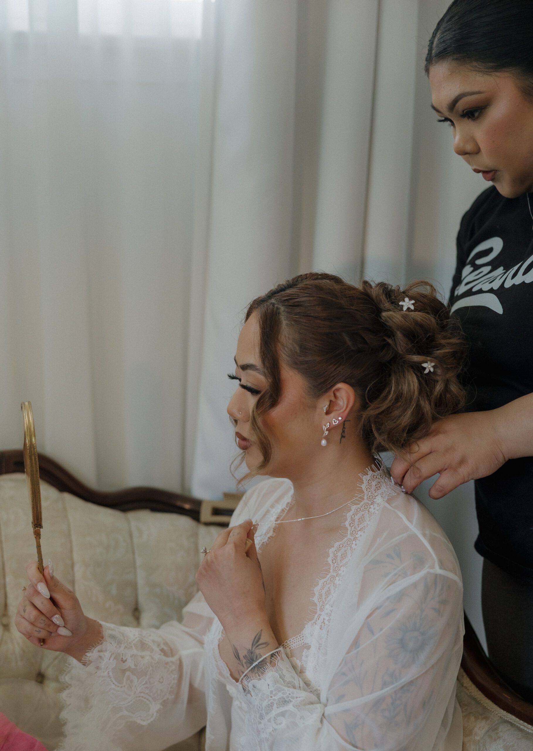 A bride having her hair and makeup done for her garden party wedding