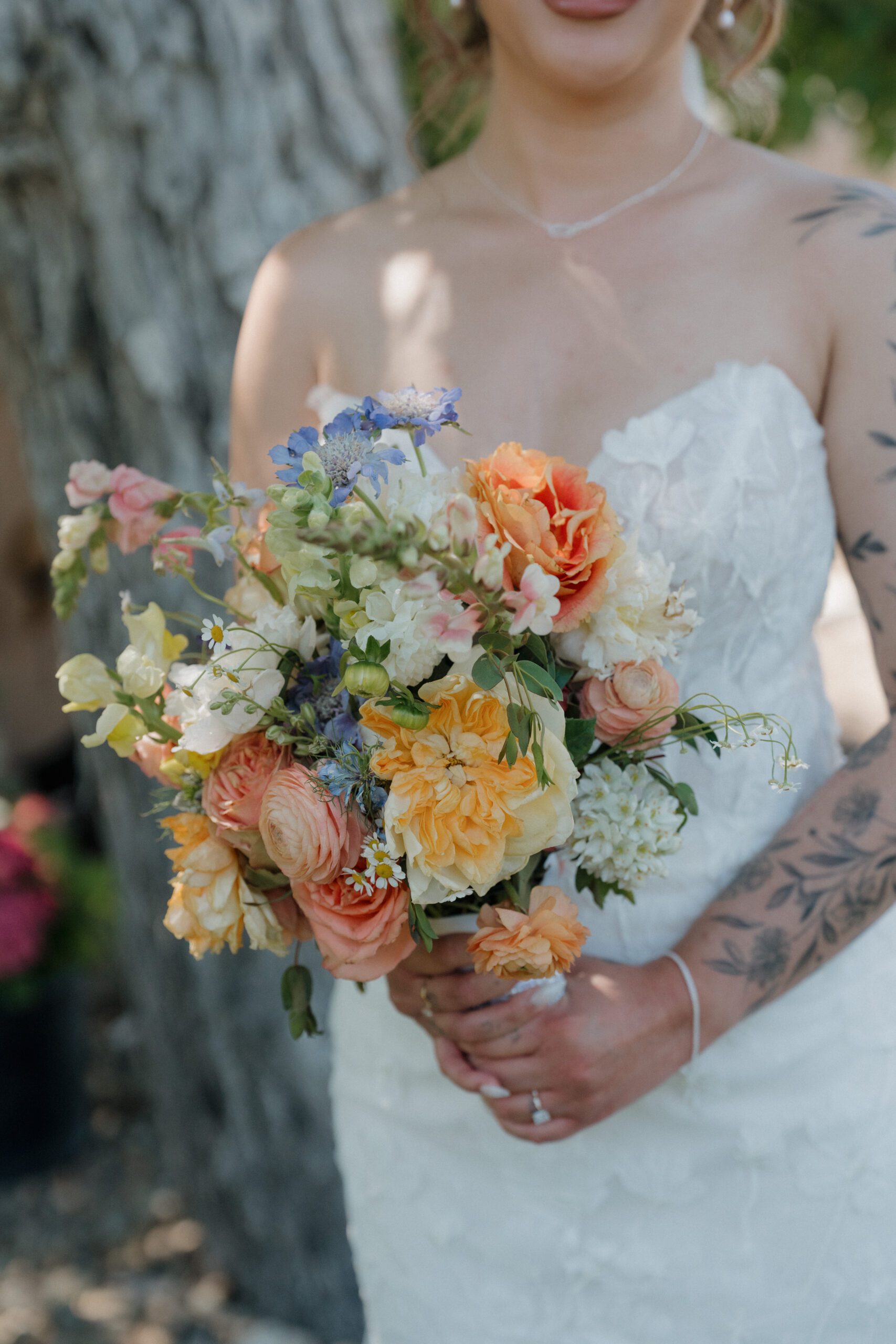 A bride's wildflower wedding bouquet from a garden party wedding
