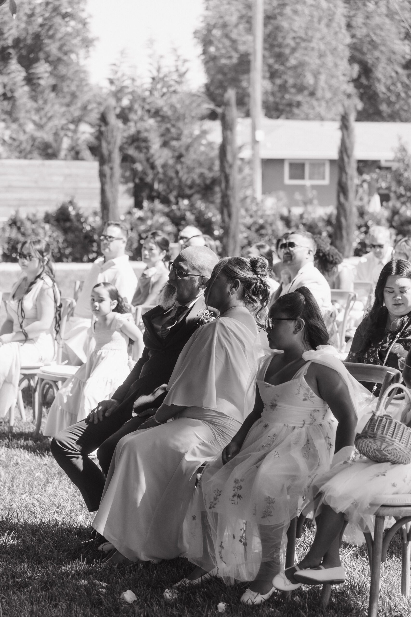 Guests watching a wedding ceremony in a black and white wedding photo