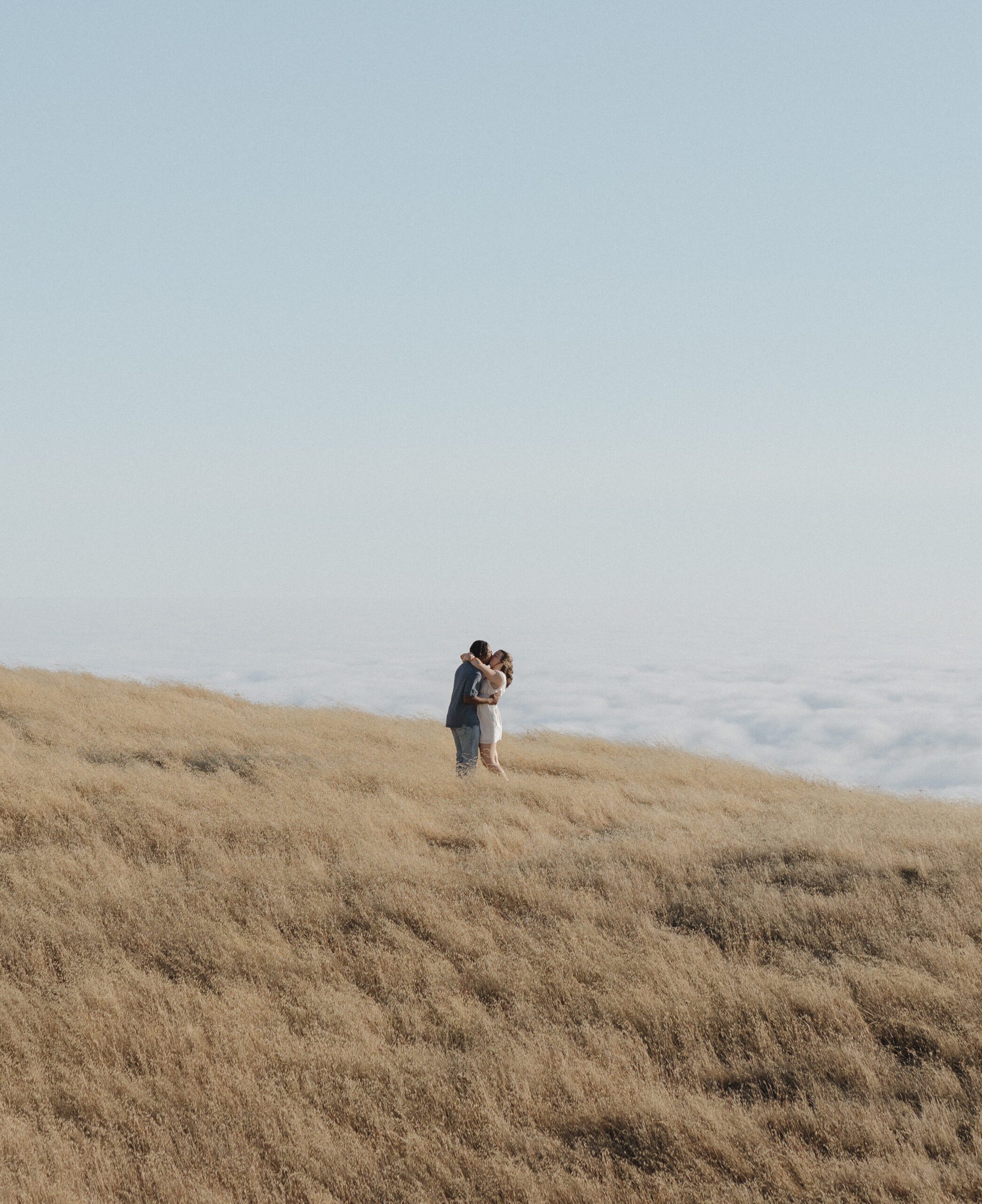 A couple kissing in a field at Mt. Tamalpais