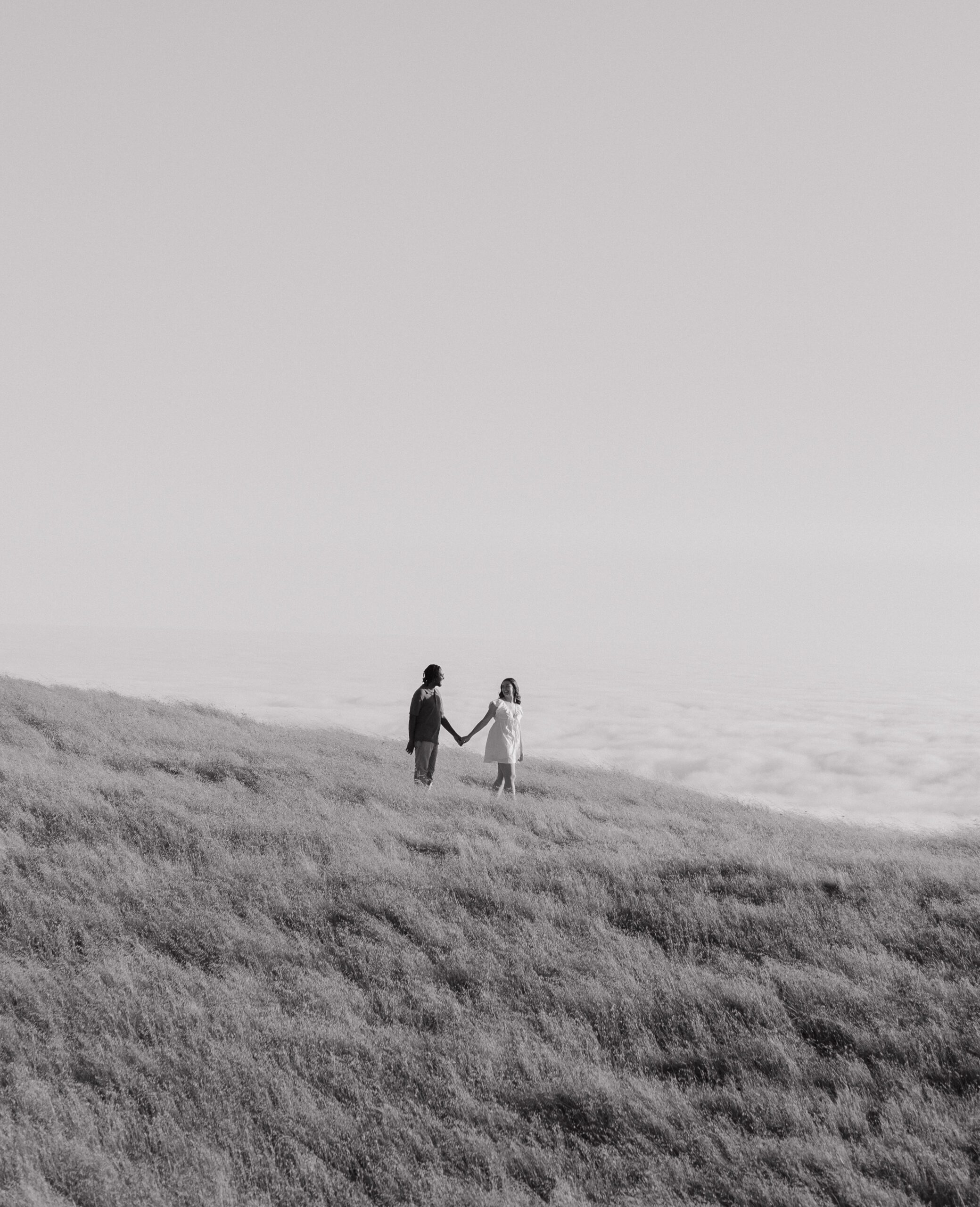 Black and white photo of couple walking down a mountain at Mt. Tamalpais