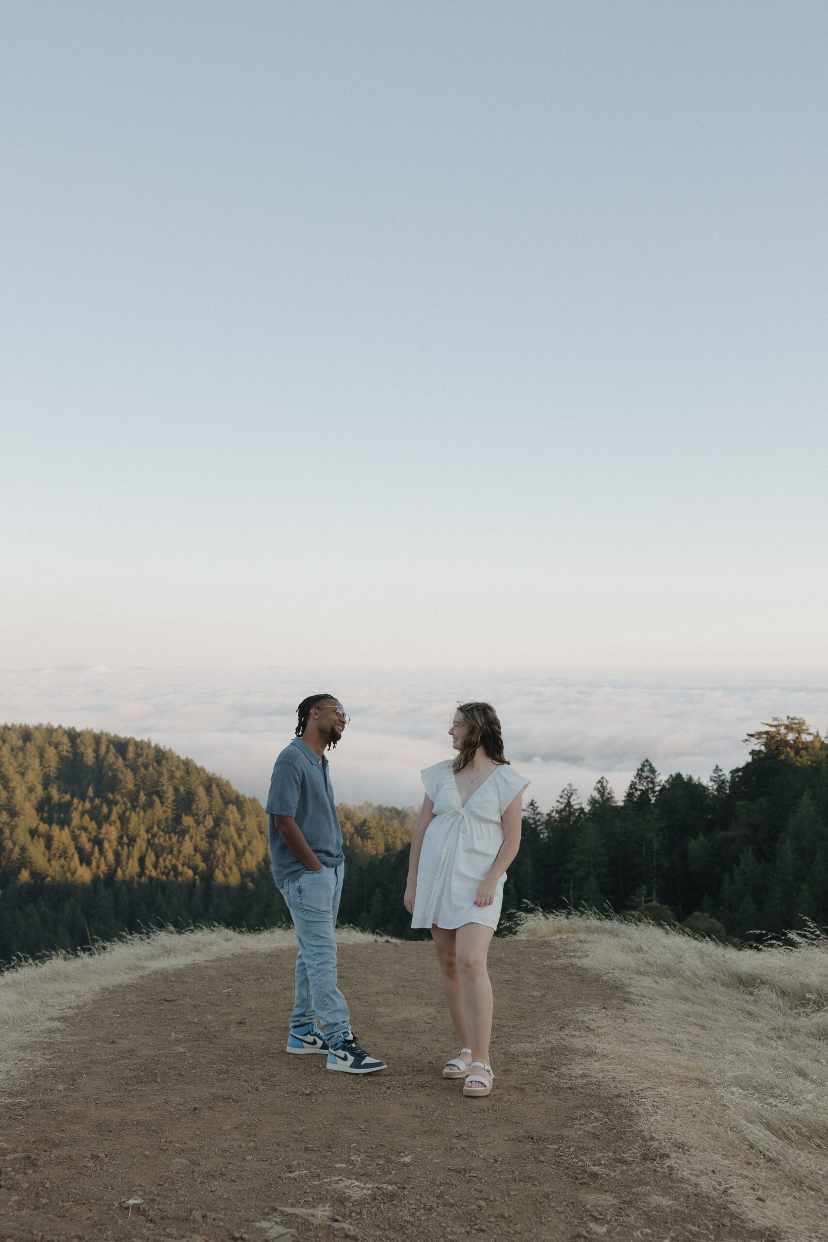 A couple standing on an overlook at Mt. Tamalpais looking at each other for a photo